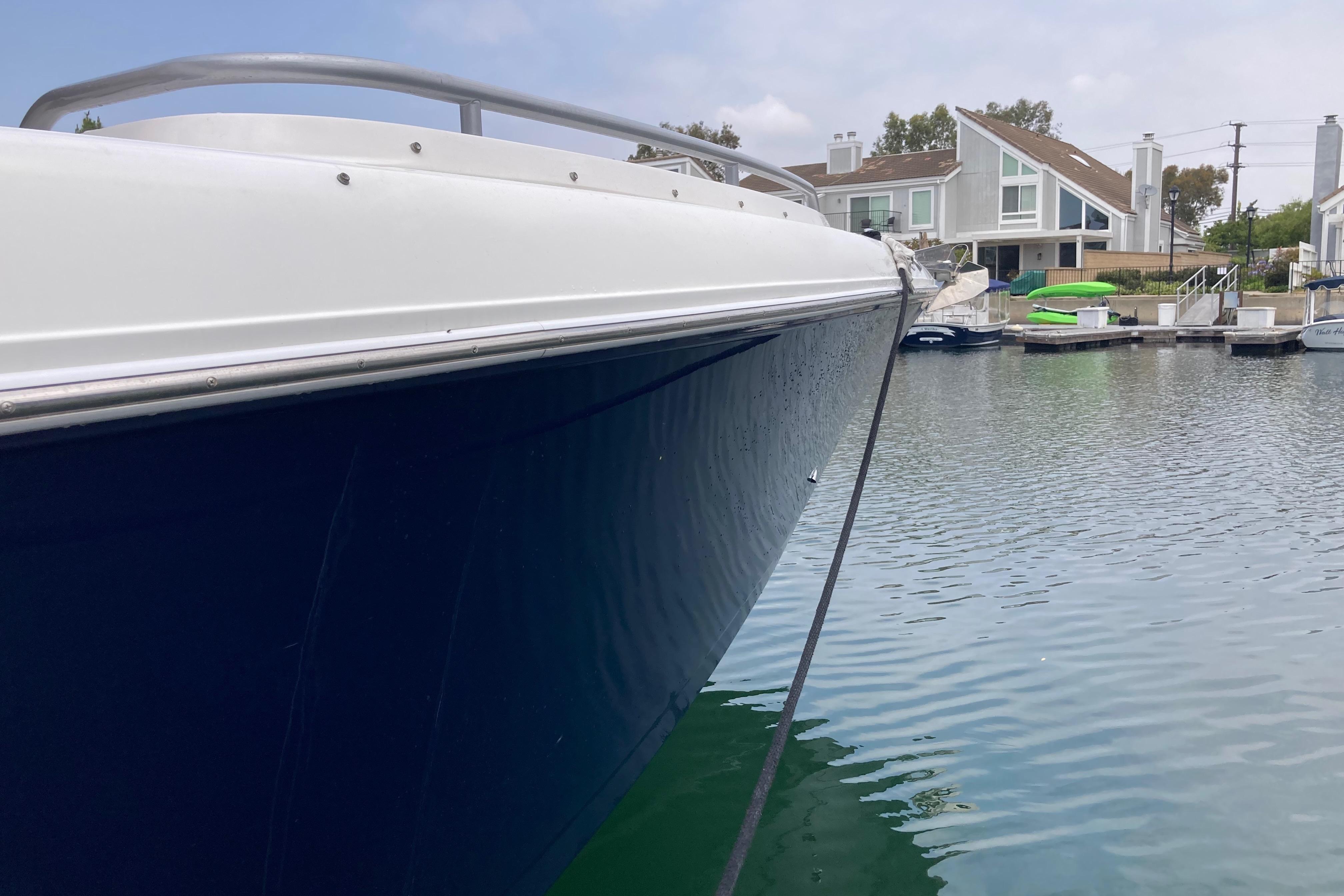 2011 Donzi 38 ZFX Open boat docked in a serene waterfront setting.