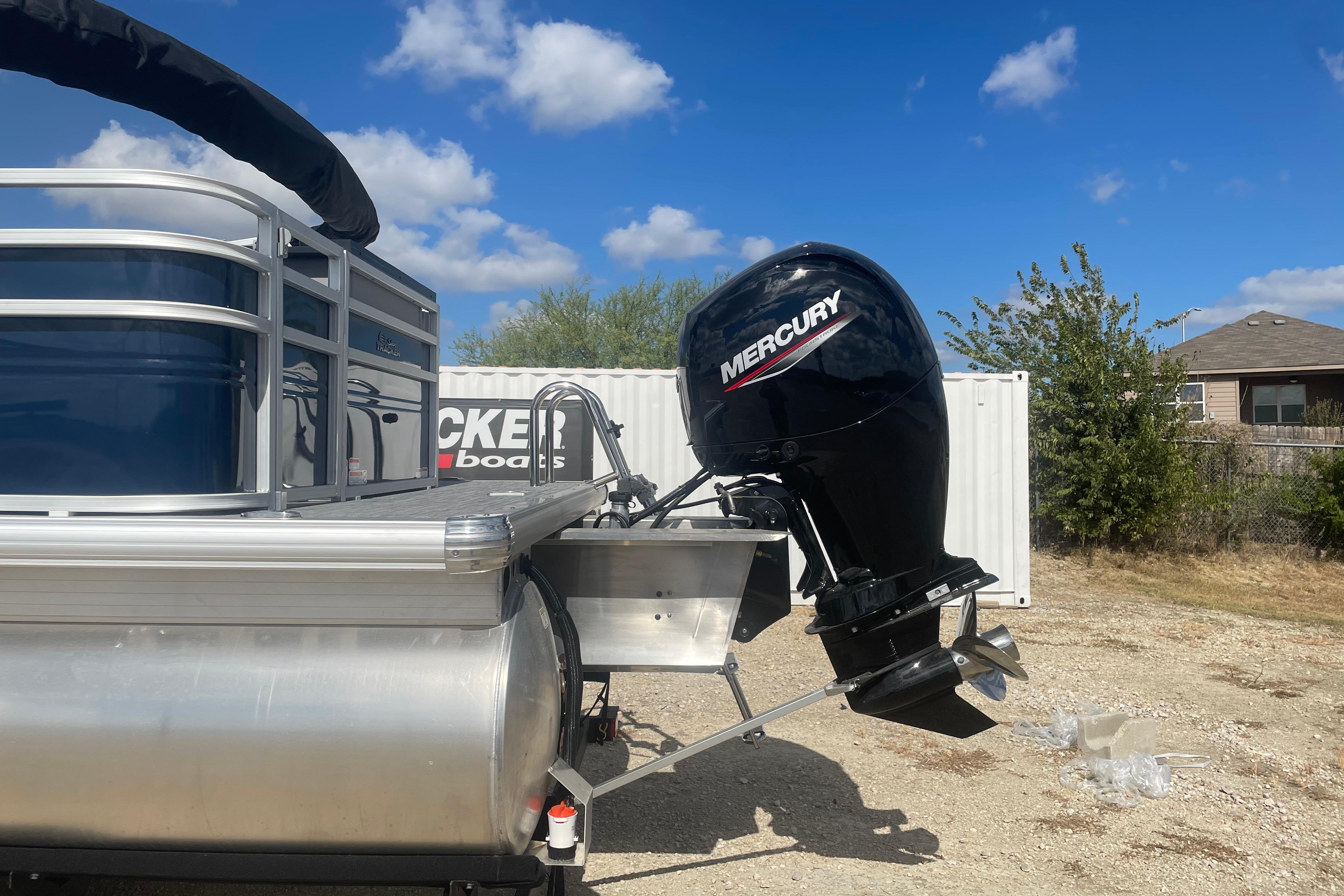 2026 Sun Tracker SportFish 22 DLX pontoon boat with Mercury outboard motor.