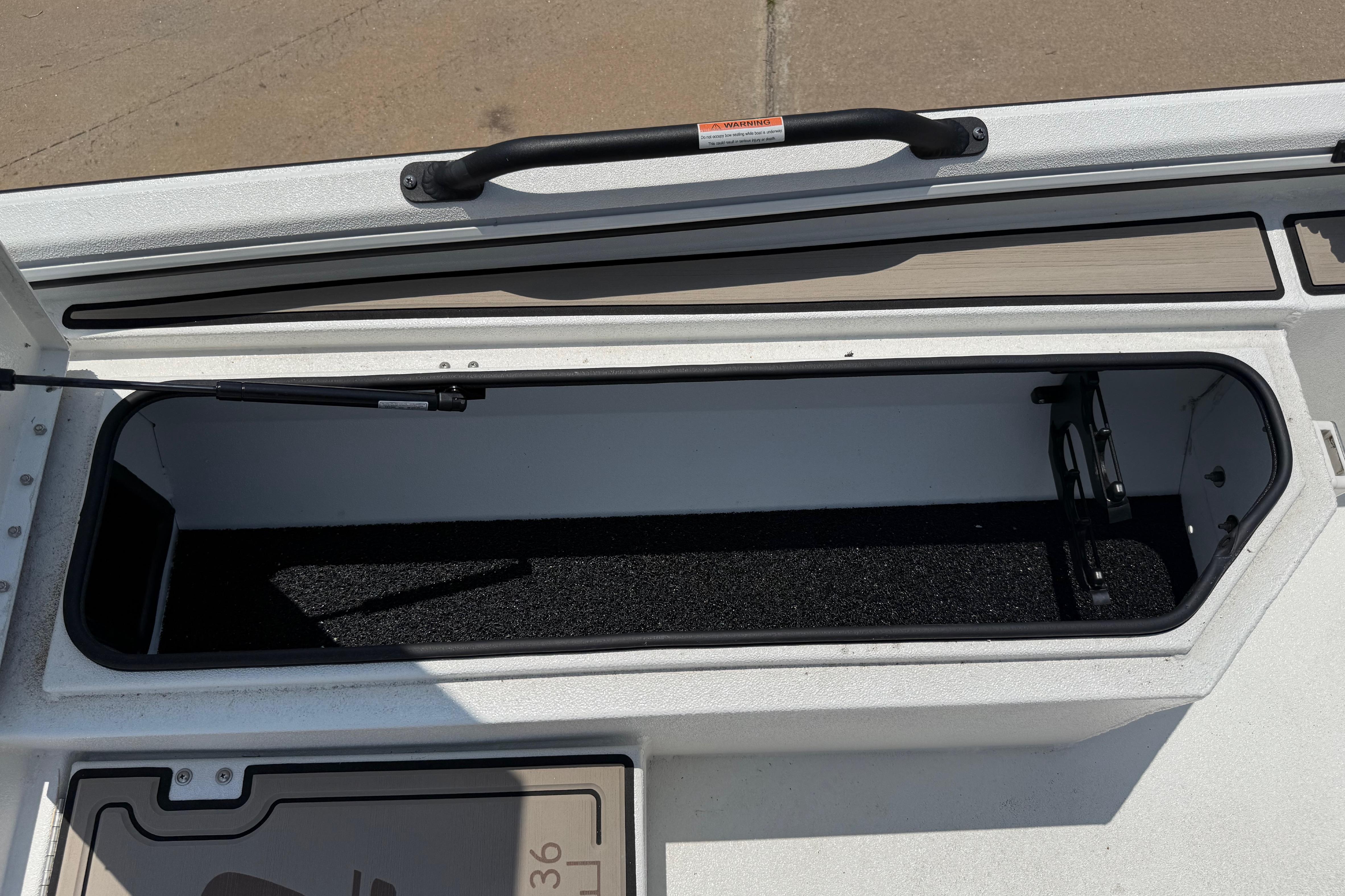Open storage compartment on 2025 Avid 22 Recon boat, featuring a sleek design and durable materials.