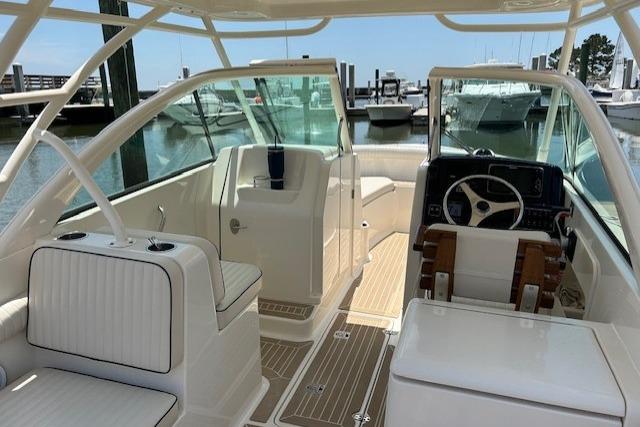 2013 Pursuit DC 265 Dual Console boat interior with seating and steering wheel.