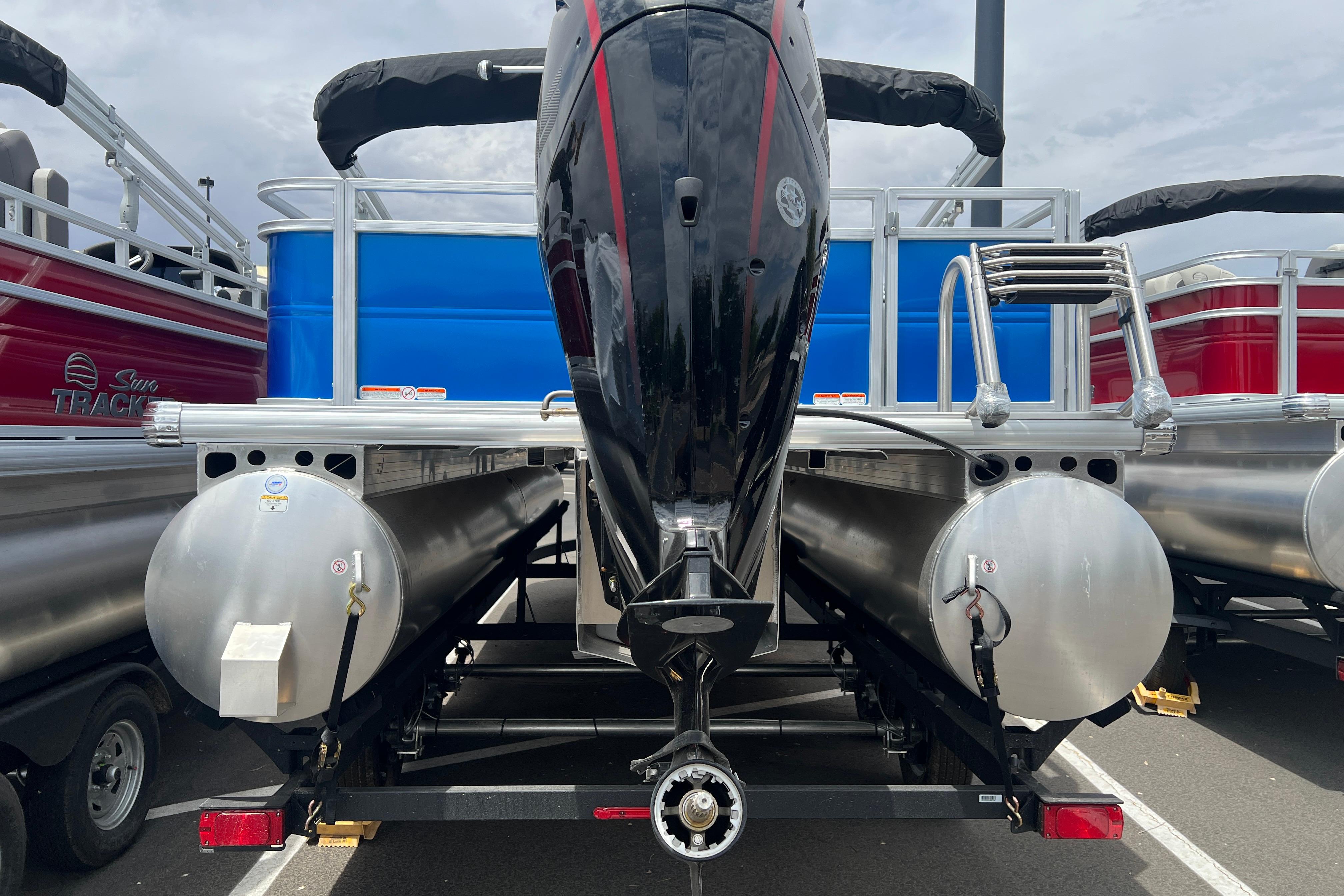 2026 Sun Tracker Party Barge 22 RF DLX pontoon boat, rear view with motor and ladder.