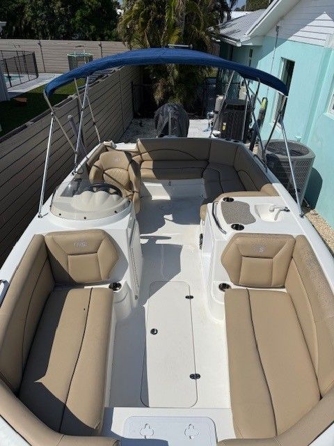 Interior view of a 2020 Nautic 203SC boat with beige seating.