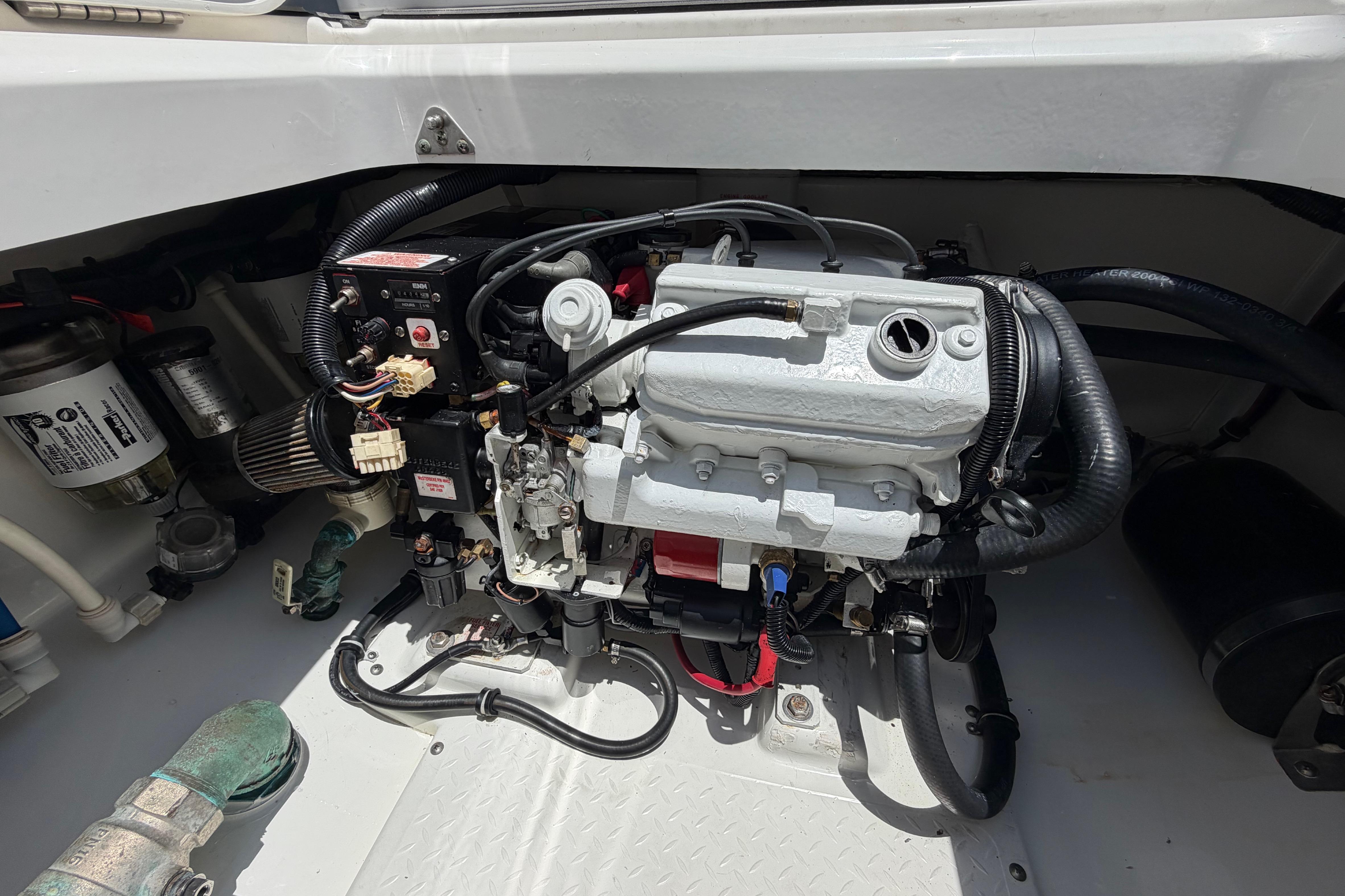 Engine compartment of a 2009 Everglades 350LX boat, showcasing detailed mechanical components.
