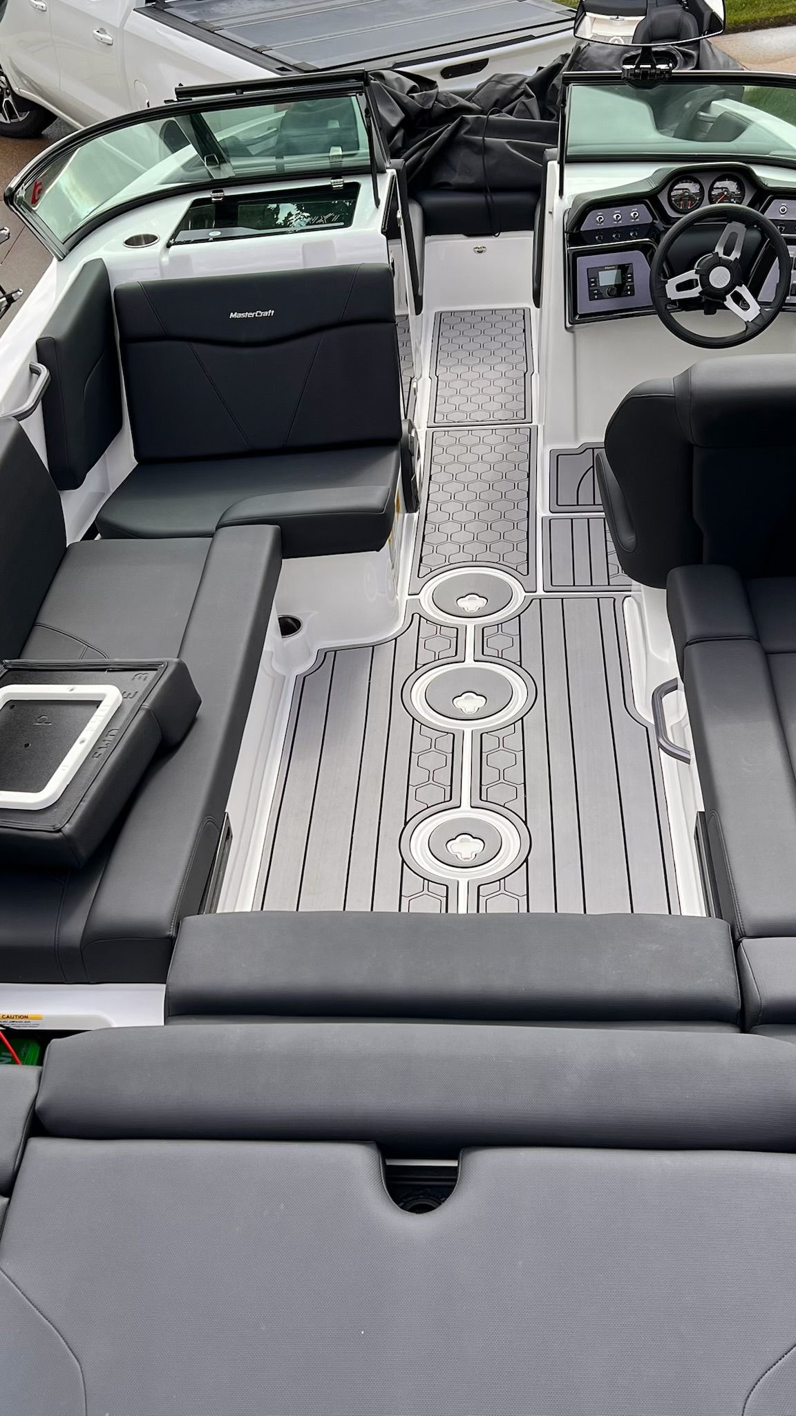 The image shows the interior of a 2020 MasterCraft NXT22 boat with sleek black seating.