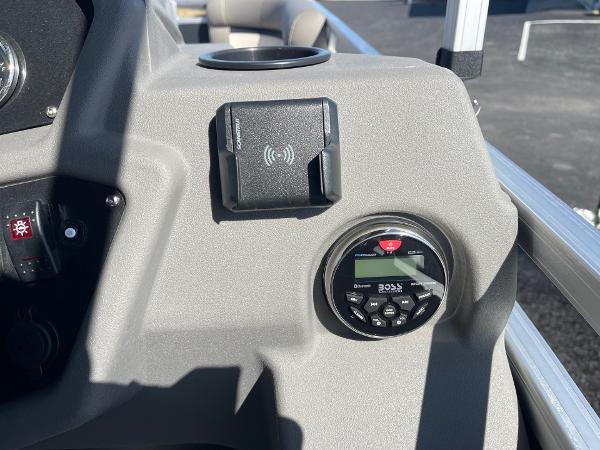 Control panel of 2025 Armada Saphir 23CR boat with audio system and wireless charger.