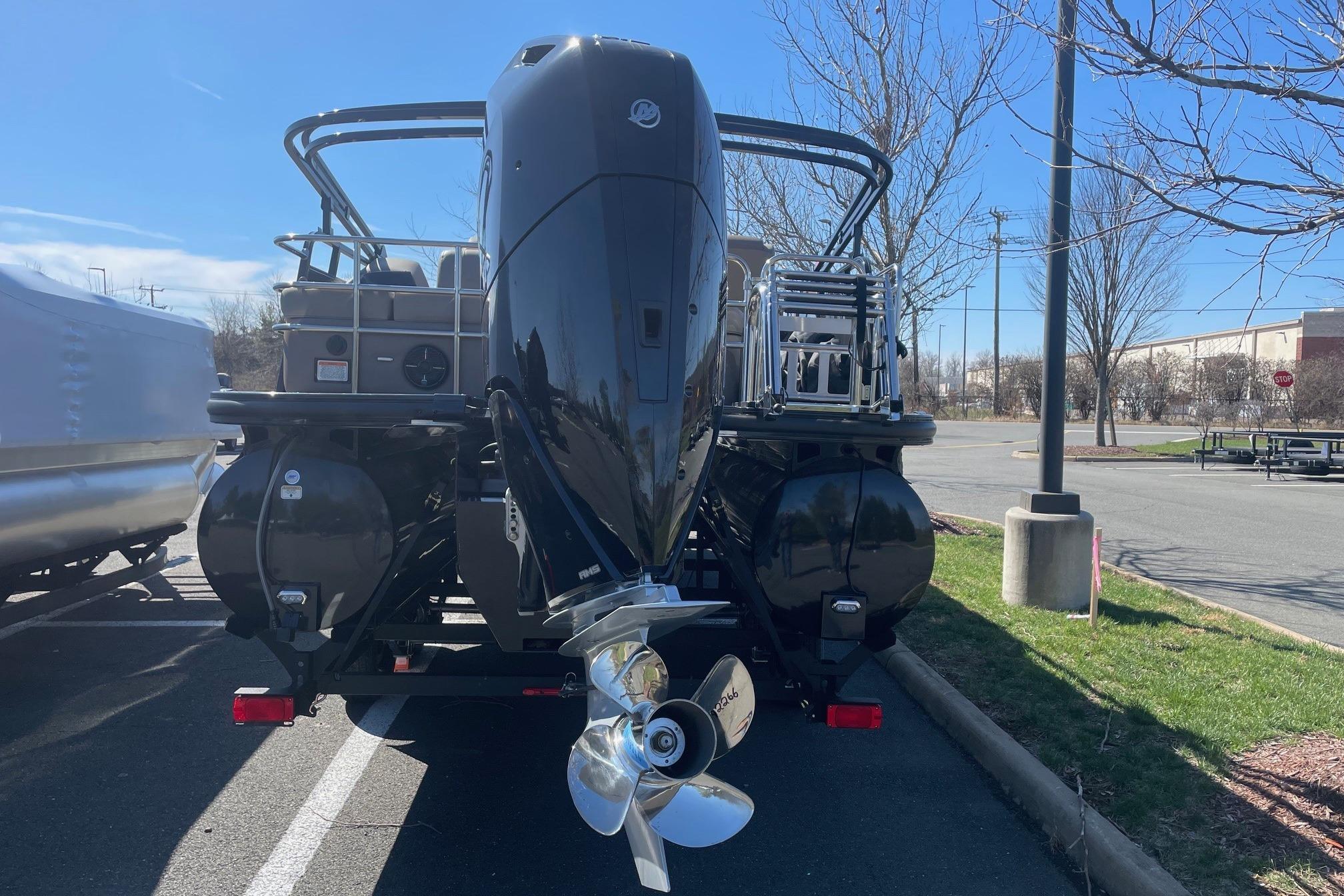 2024 Ranger 2500LS boat with powerful outboard motor in a parking lot.