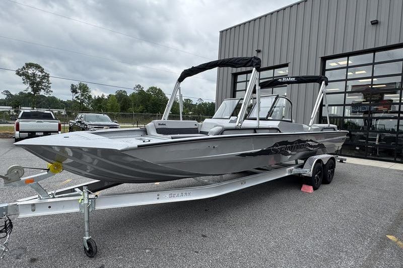 2025 SeaArk Super Lounge Easy boat on trailer outside a building.