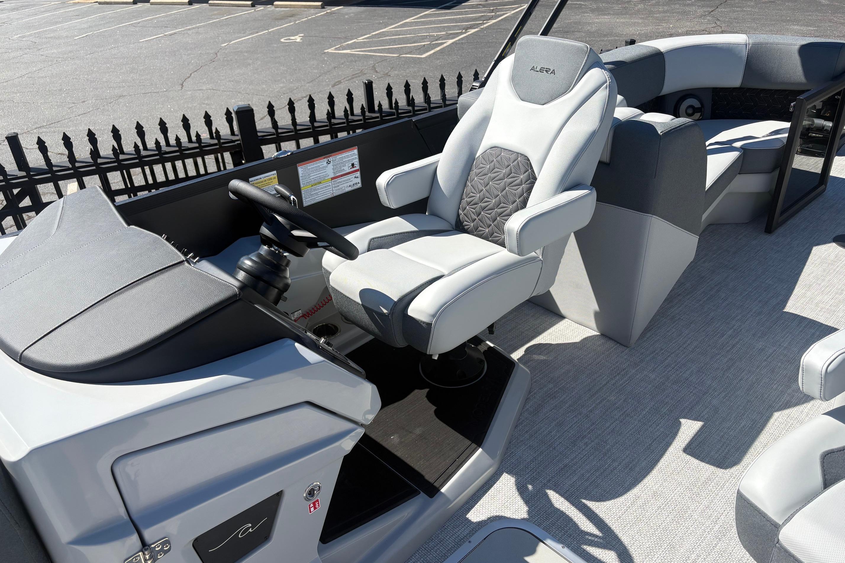 Captain's seat of 2026 Alera 23Q boat, featuring modern design and comfortable upholstery.