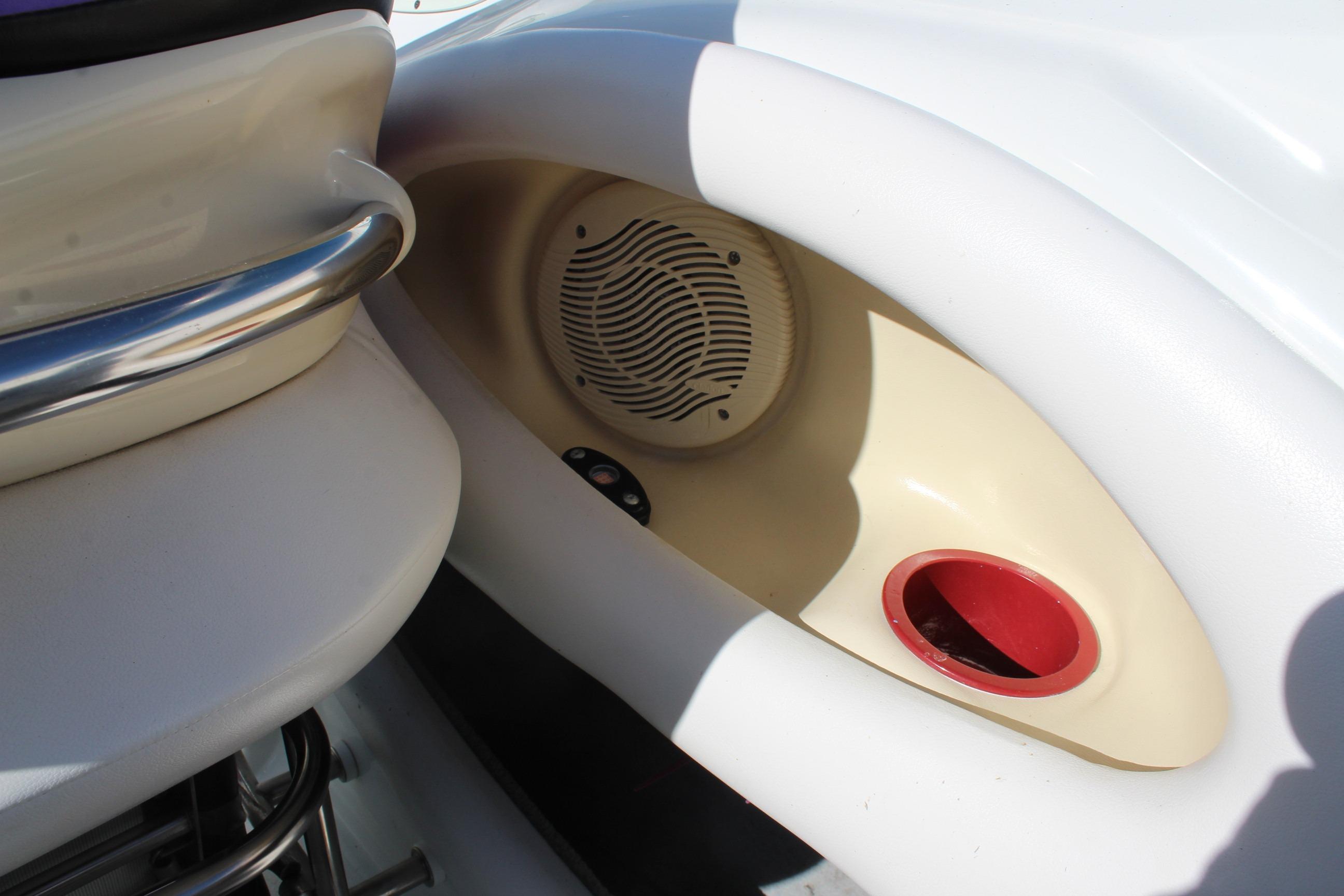 1996 Baja 232 boat interior with speaker and cup holder detail.