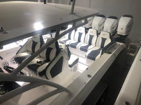 2019 Midnight Express 39 Cuddy boat interior with luxurious seating and multiple engines.