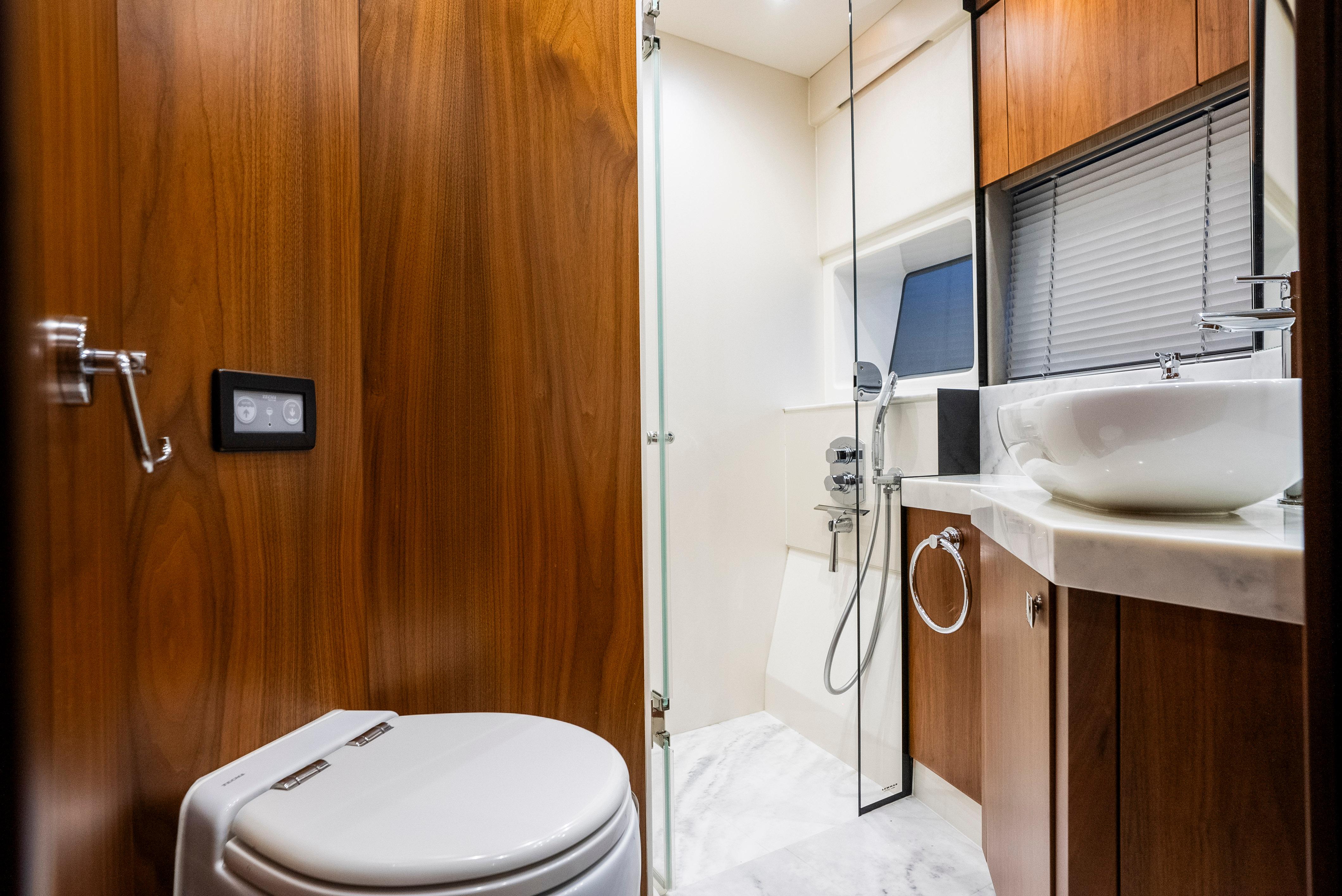Luxurious bathroom in 2017 Sunseeker Manhattan 66 yacht with modern fixtures and wooden accents.