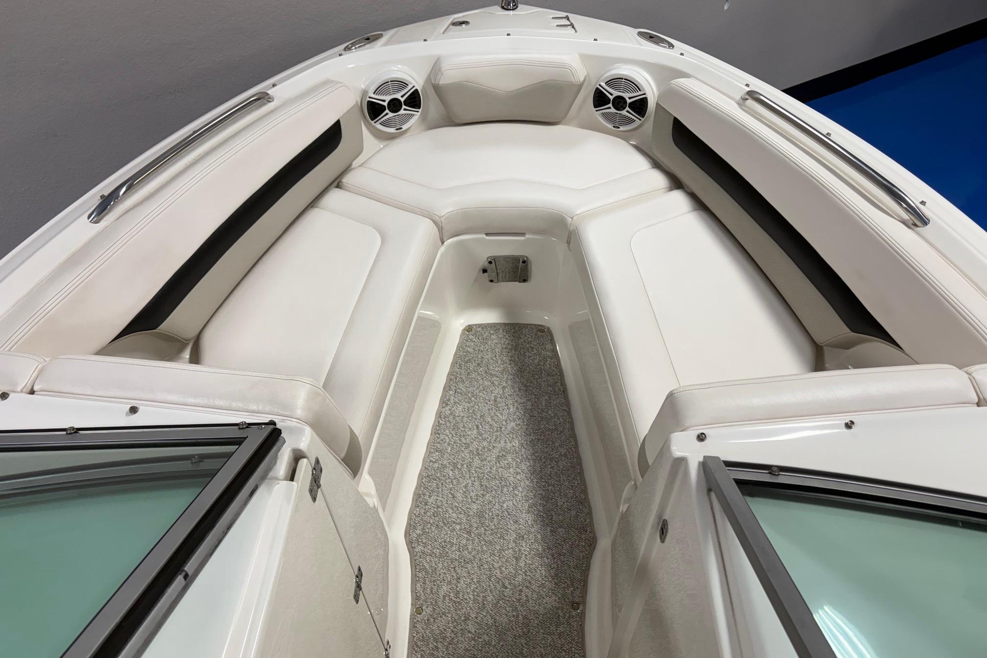 2011 Chaparral 216 SSi boat interior with white seating and speakers.
