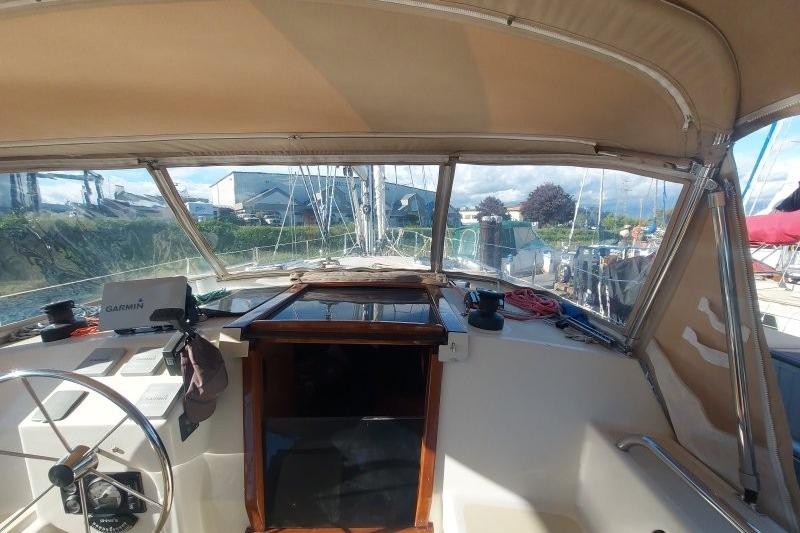 Interior view of 2019 Custom Chatam Extreme 42 sailboat cockpit with steering wheel and navigation equipment.
