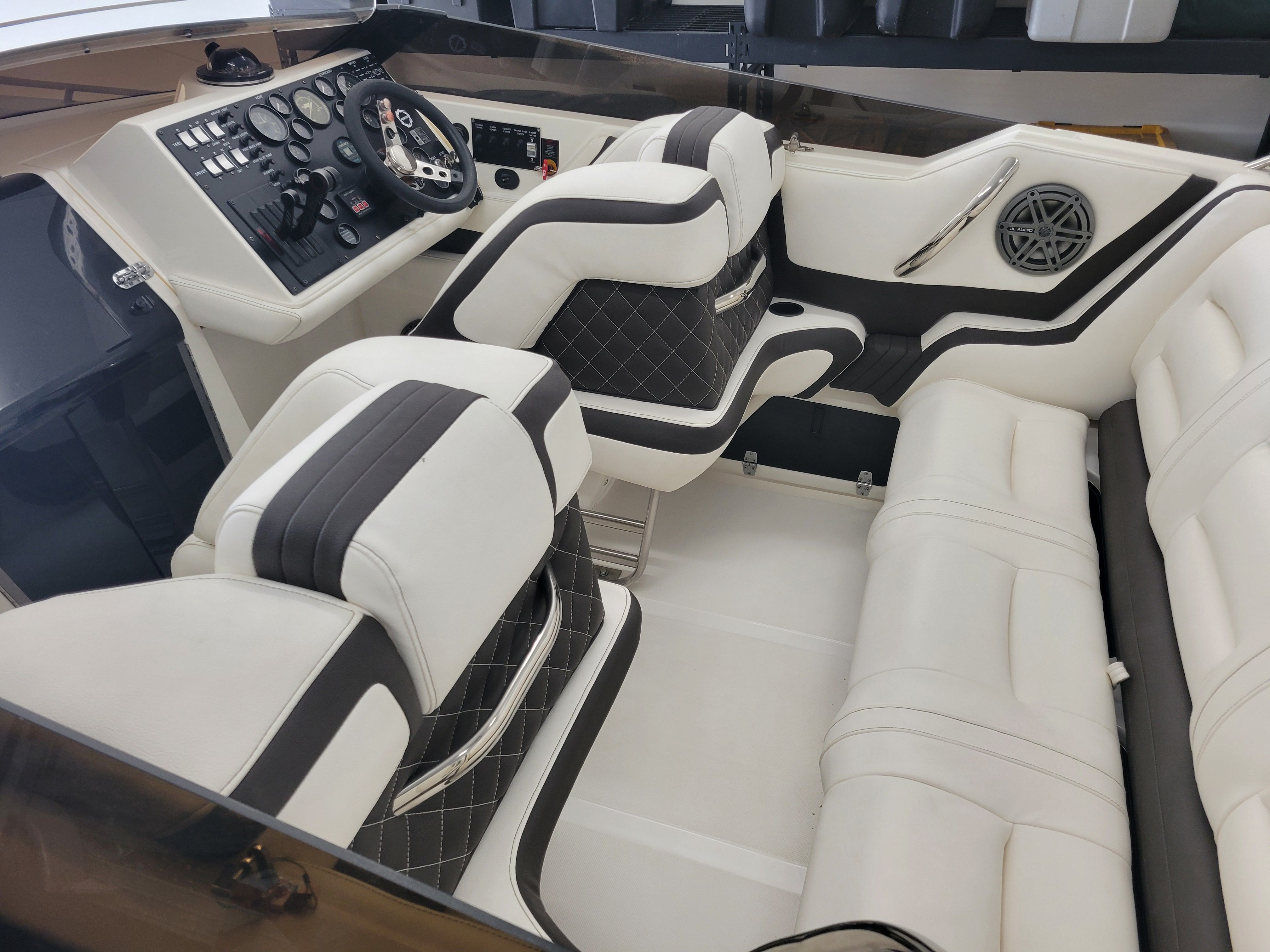 1992 Fountain Fever boat interior with white and black seating, steering wheel, and control panel.