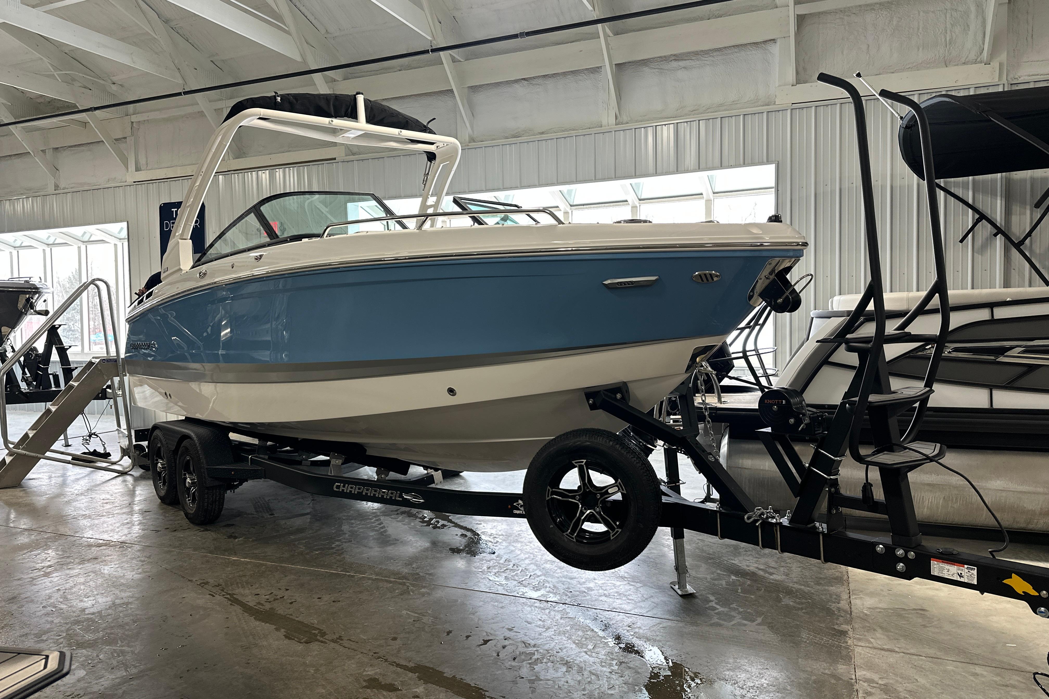 2026 Chaparral SSX 6 boat on trailer in showroom.