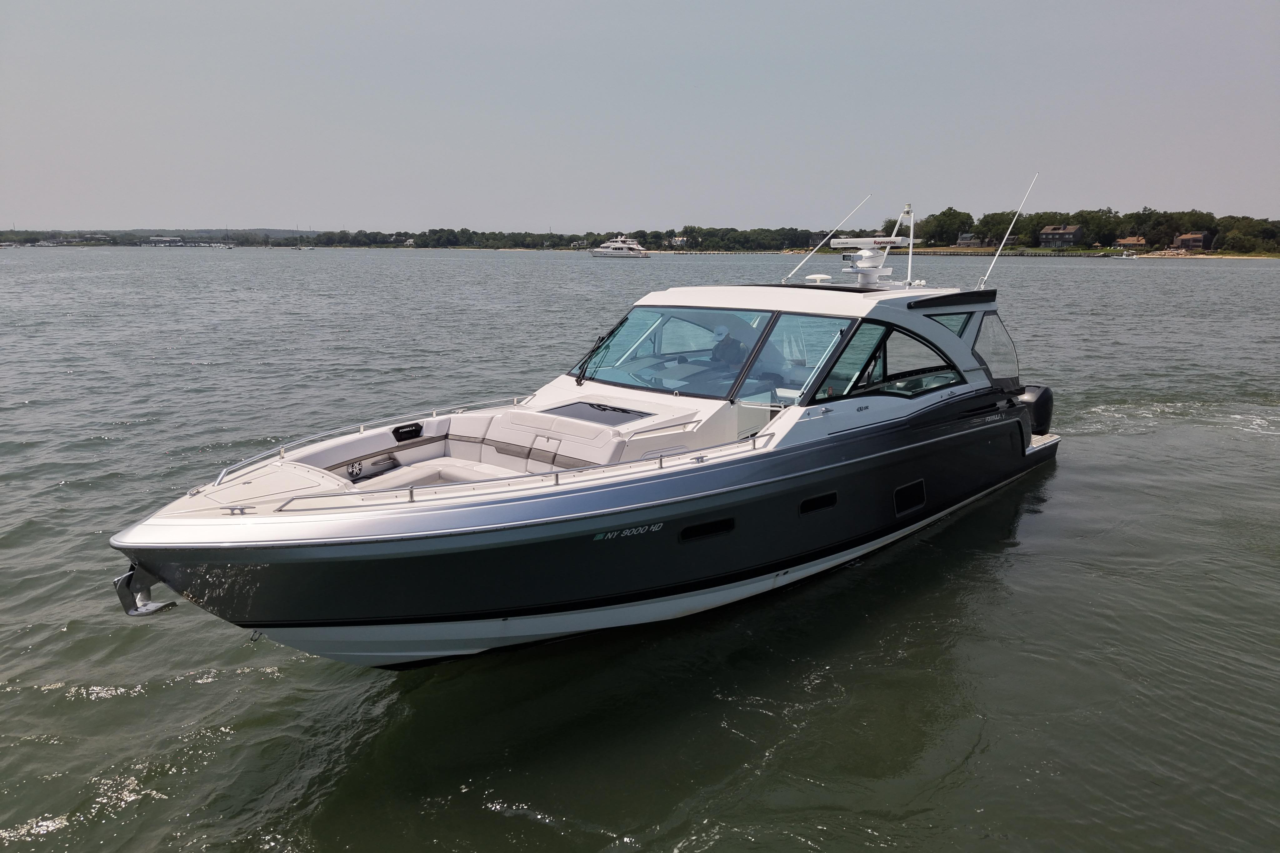 2019 Formula 430 Super Sport Crossover boat cruising on a calm lake.