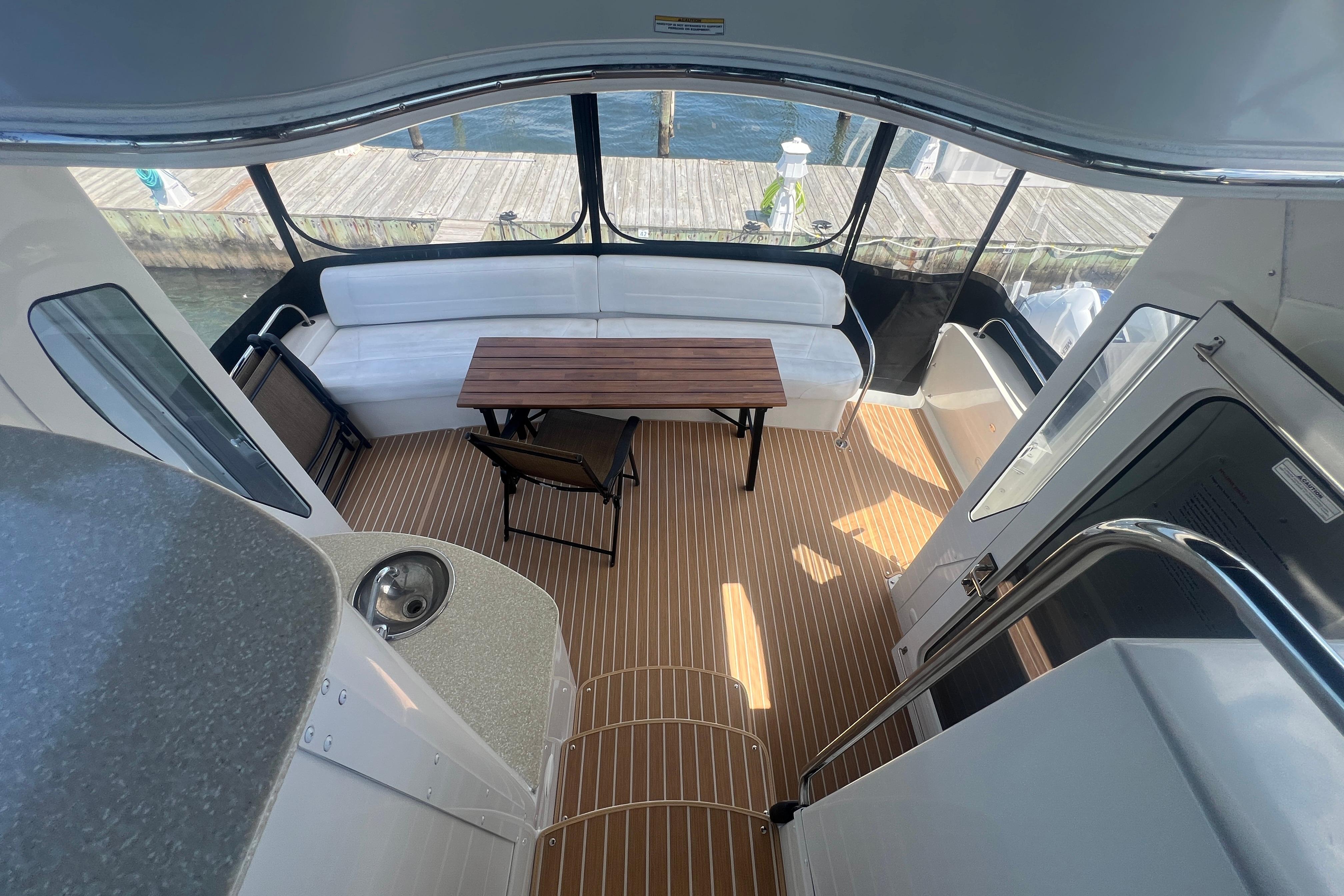 2006 Carver 43 Motor Yacht interior with seating, table, and wood flooring.