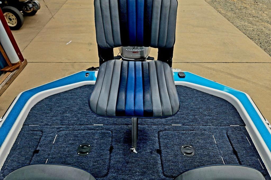 1996 Champion 181 SX boat interior with blue and gray seating and carpeted deck.