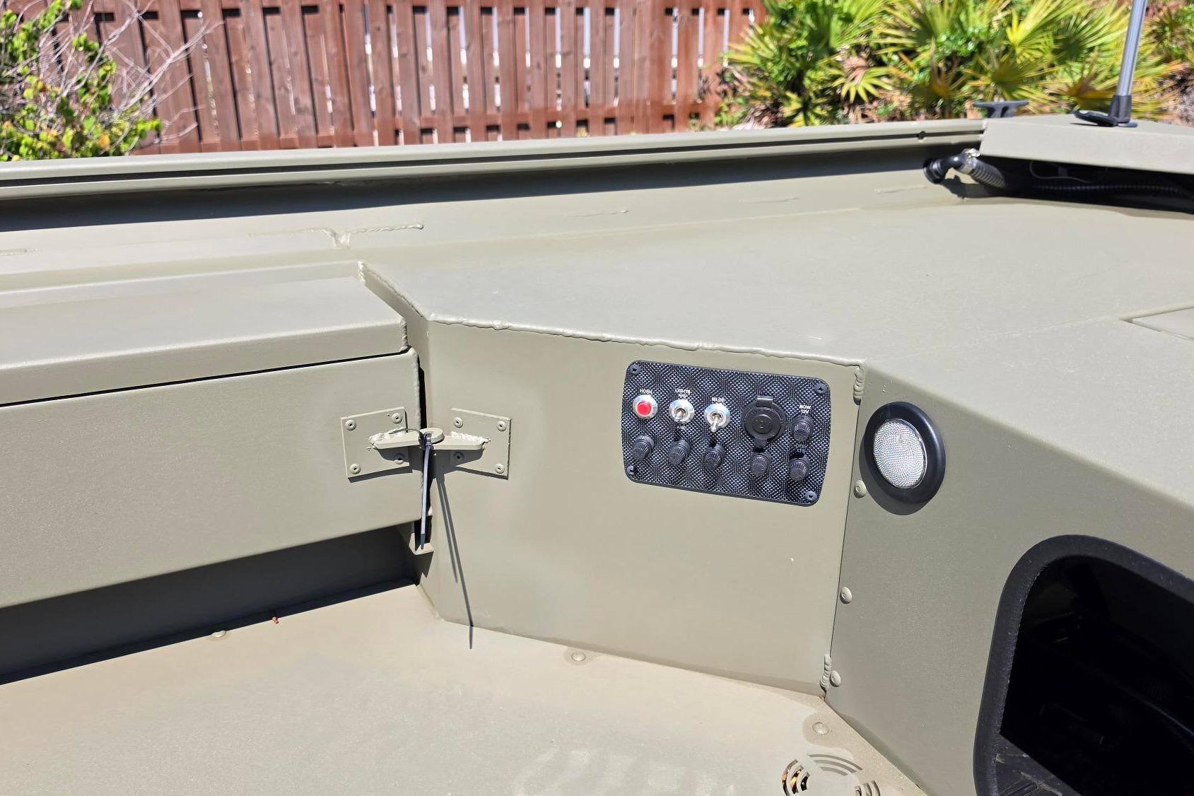 Control panel of 2026 Tracker Grizzly 1654 T Sportsman boat, featuring switches and buttons.