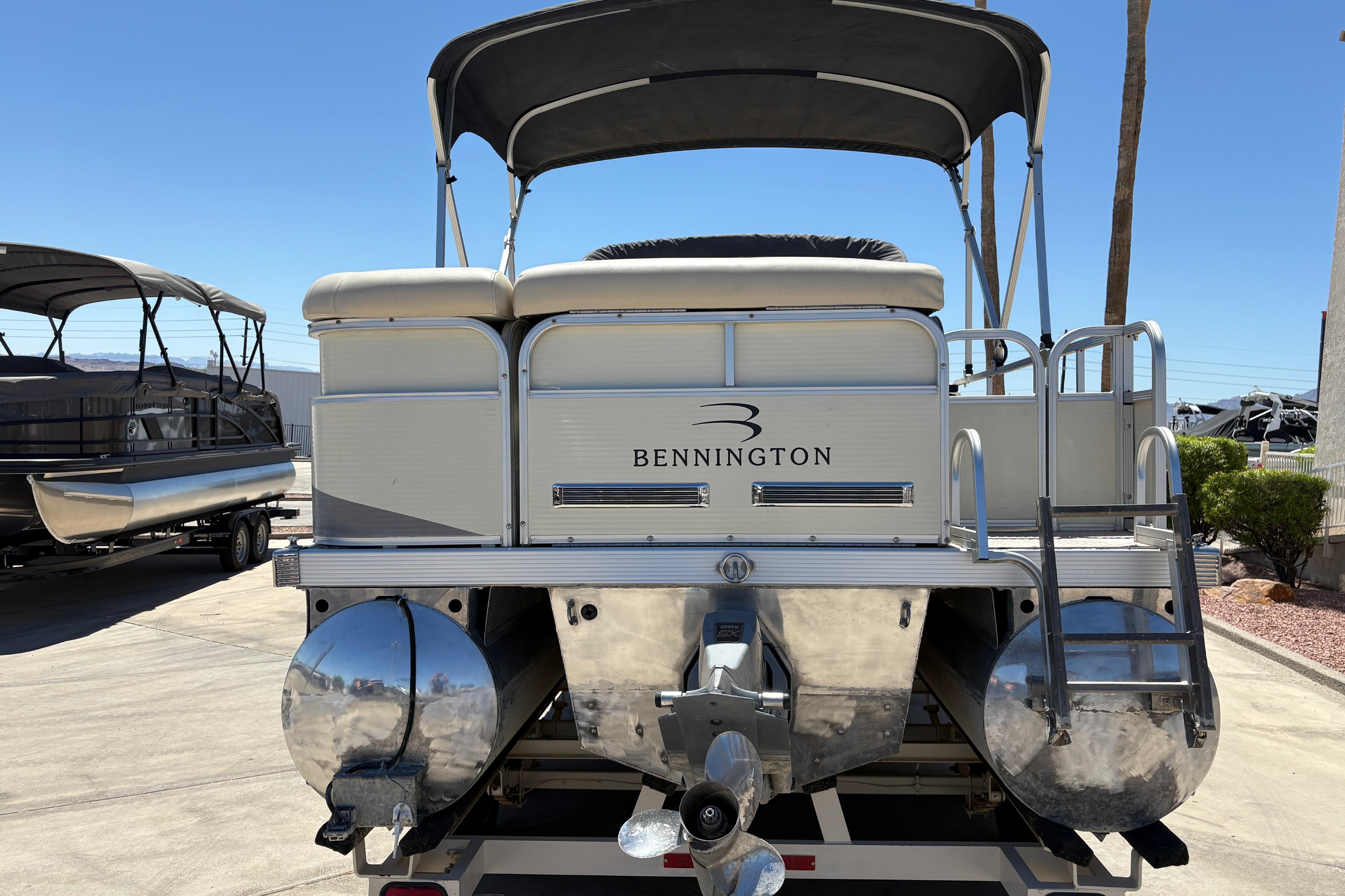 2005 Bennington 2575RFS I/O pontoon boat, rear view with canopy and ladder.
