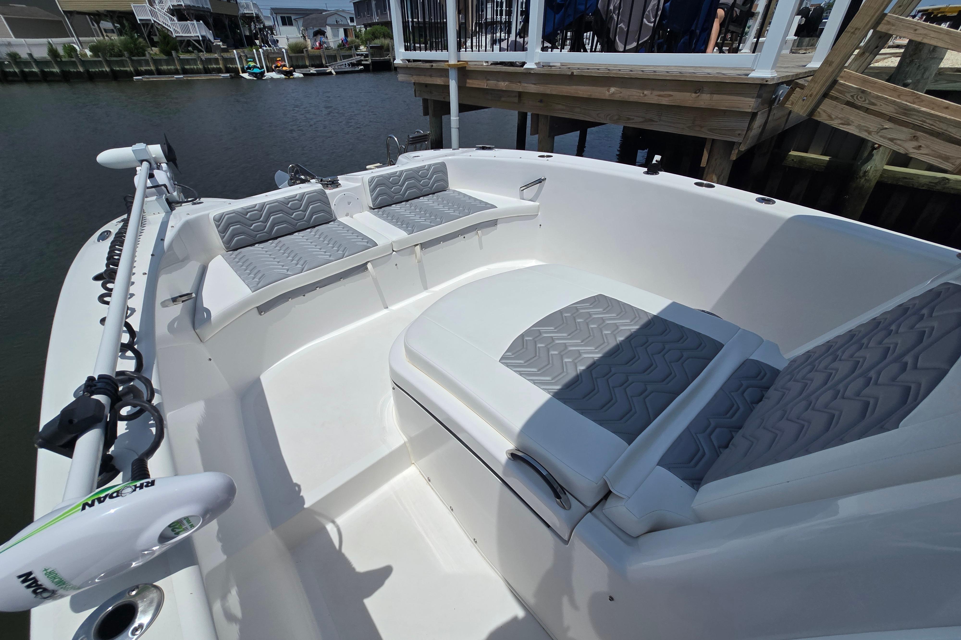 2021 Twin Vee 280 GFX CC boat interior with cushioned seating and water view.