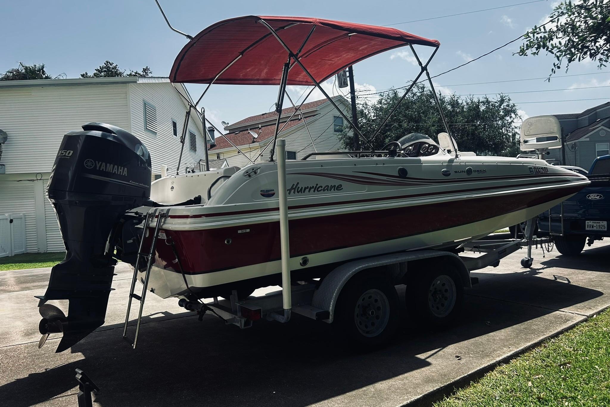 2013 Hurricane SunDeck Sport 201 OB boat with Yamaha engine on trailer.