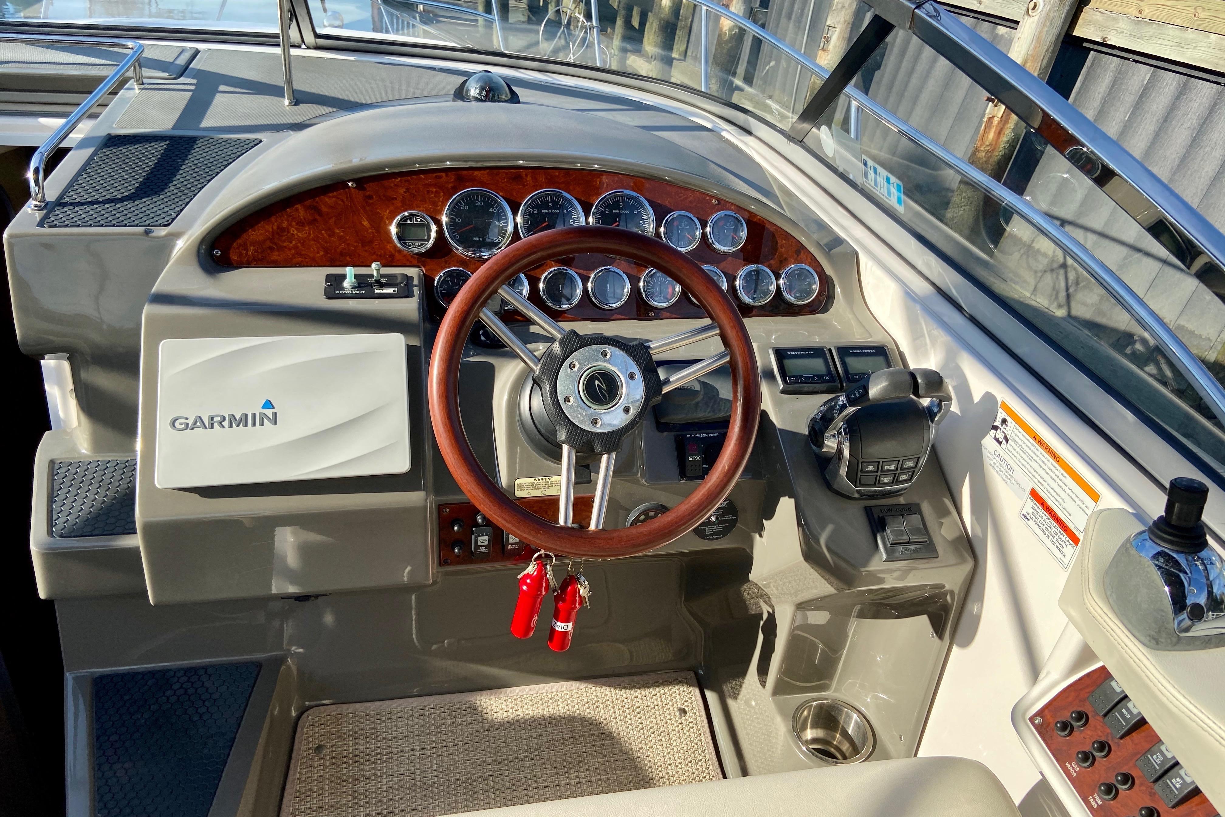 2012 Regal 35 Express Cruiser helm with Garmin navigation and wood-accented steering wheel.