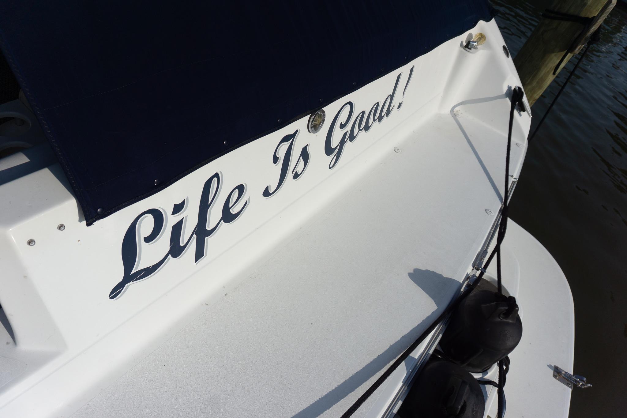 1993 Sea Ray 400 Express Cruiser with "Life Is Good!" text on the stern.