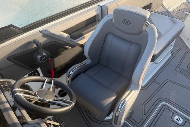 2023 Cobalt R6 Surf boat interior with steering wheel and captain's chair.