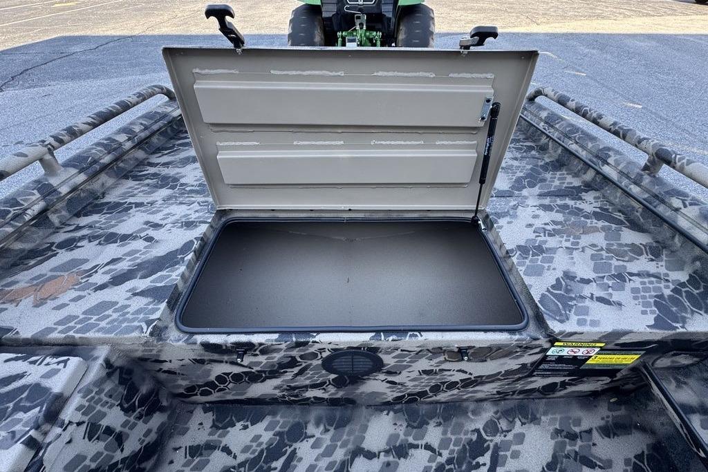 Open storage compartment on 2025 Havoc 1860 boat with camouflage pattern.
