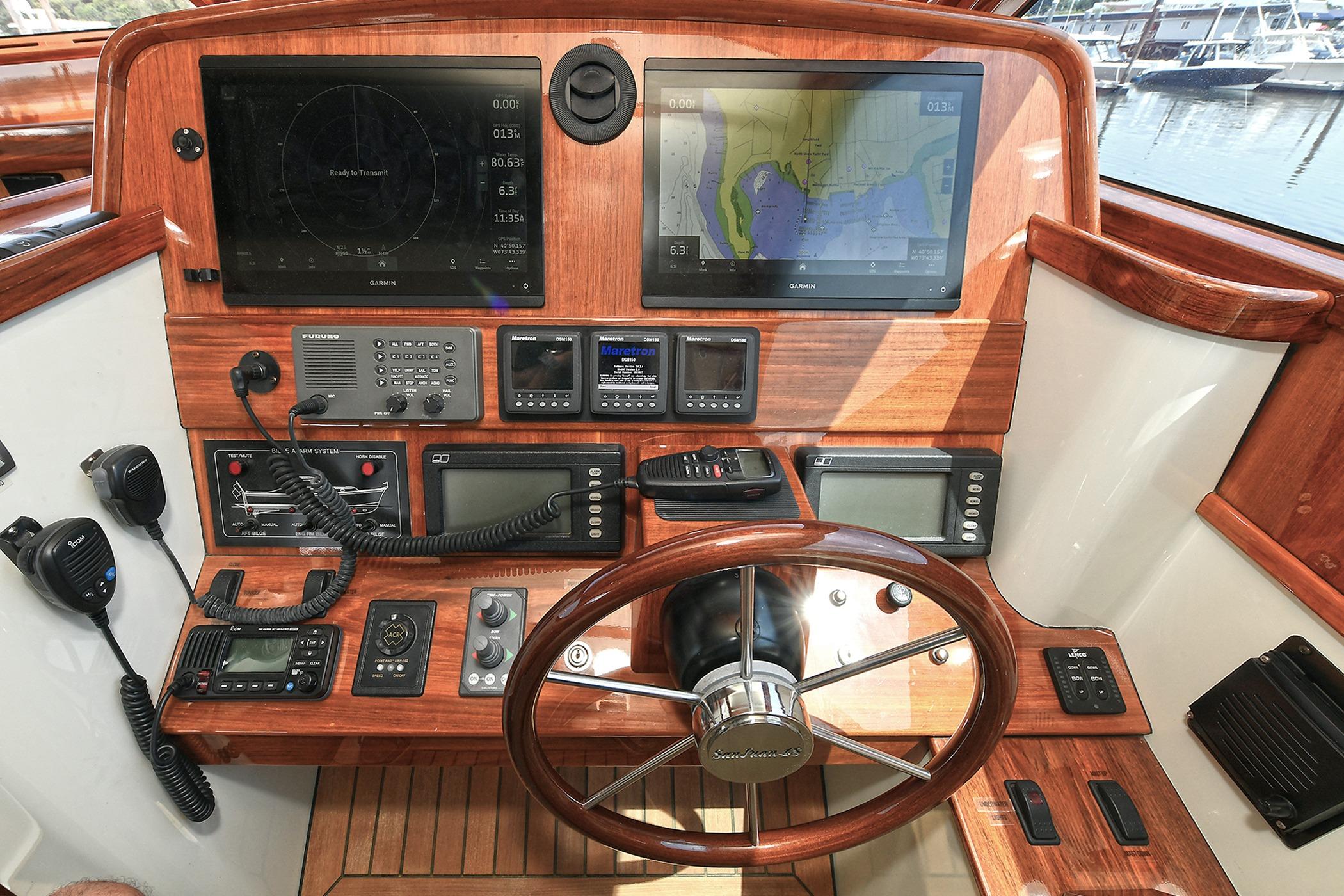 2005 San Juan Downeast Express helm with navigation screens and controls.