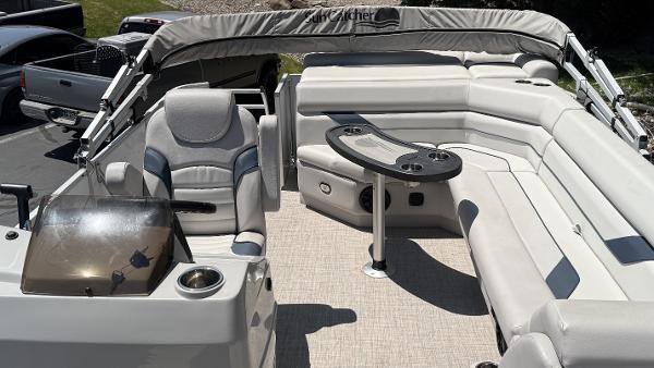 2023 SunCatcher Select 322FC boat interior with seating and table, featuring modern design.