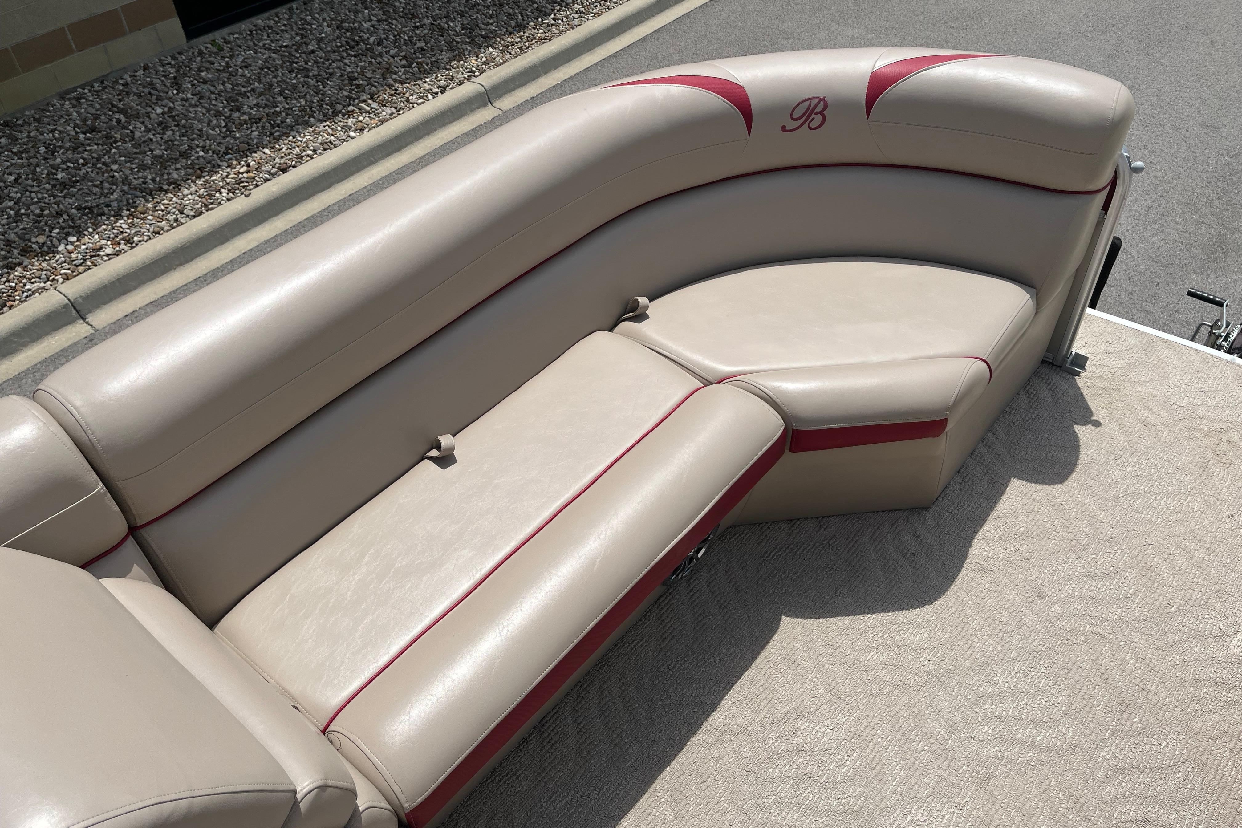 2013 Berkshire 230CL CTS boat seating with beige upholstery and red accents.