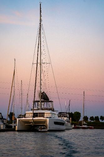 2021 Bali 4.8 catamaran at sunset in a serene marina setting.