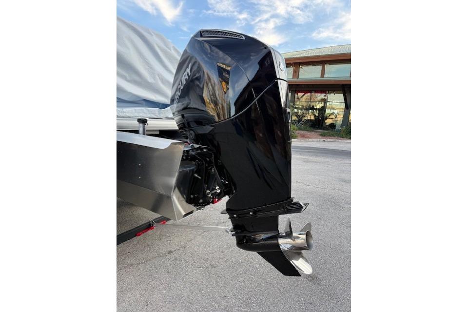 2026 Sun Tracker Fishin' Barge 22 XP3 with Mercury outboard motor, parked outdoors.