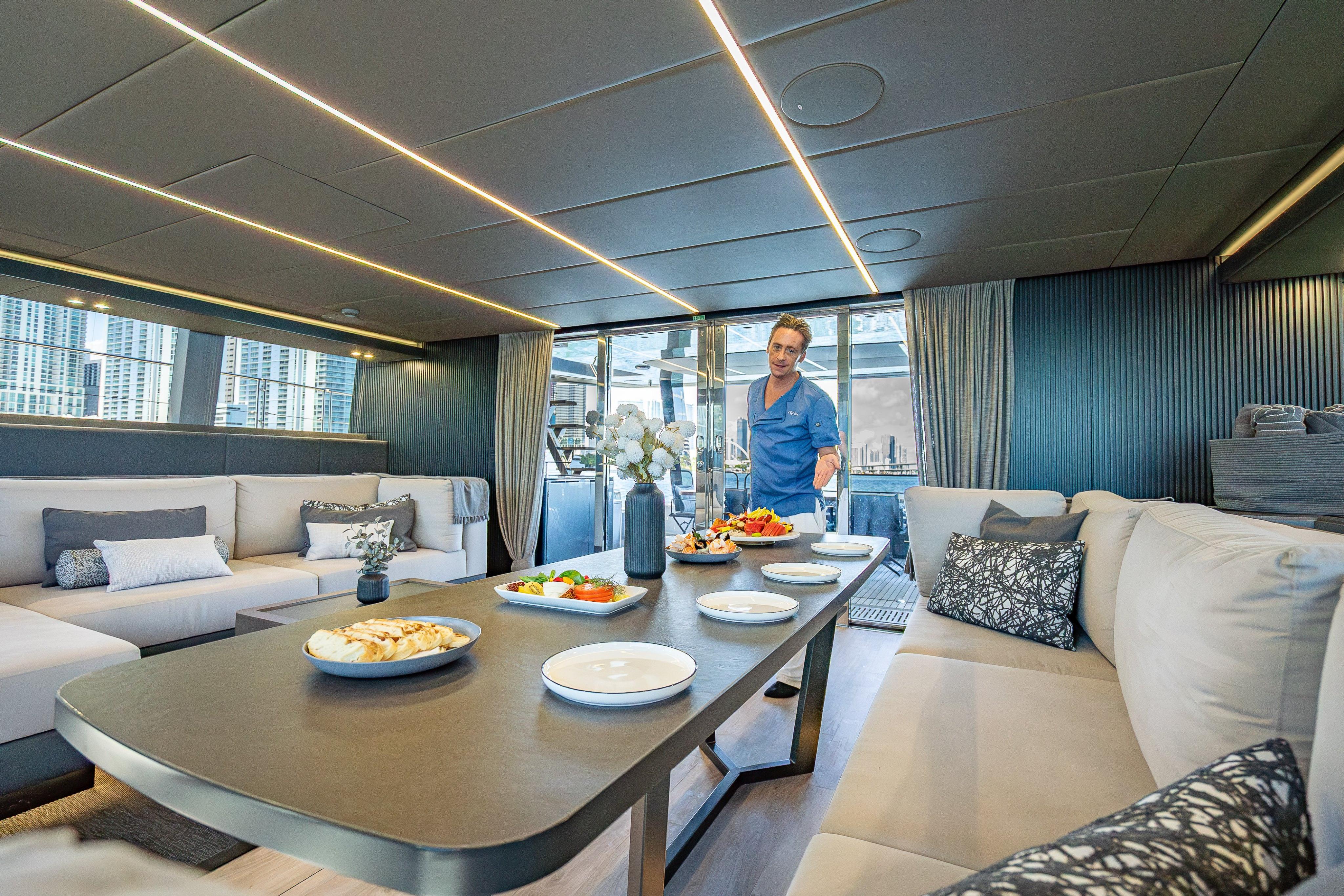 Luxurious interior of 2026 Sunreef 60 Power yacht with elegant dining setup.