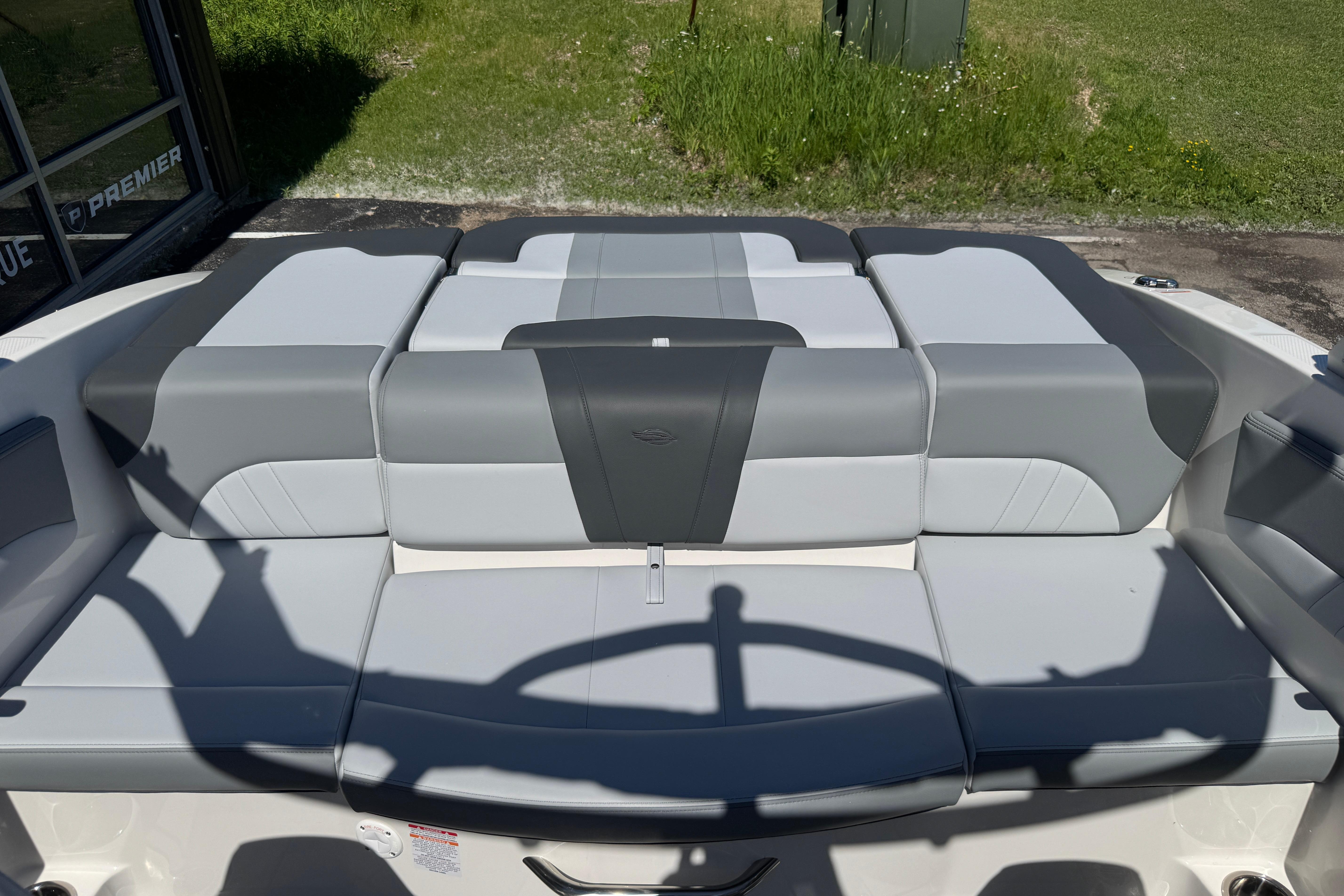 2026 Chaparral 21 SSi boat interior with gray and white cushioned seating.