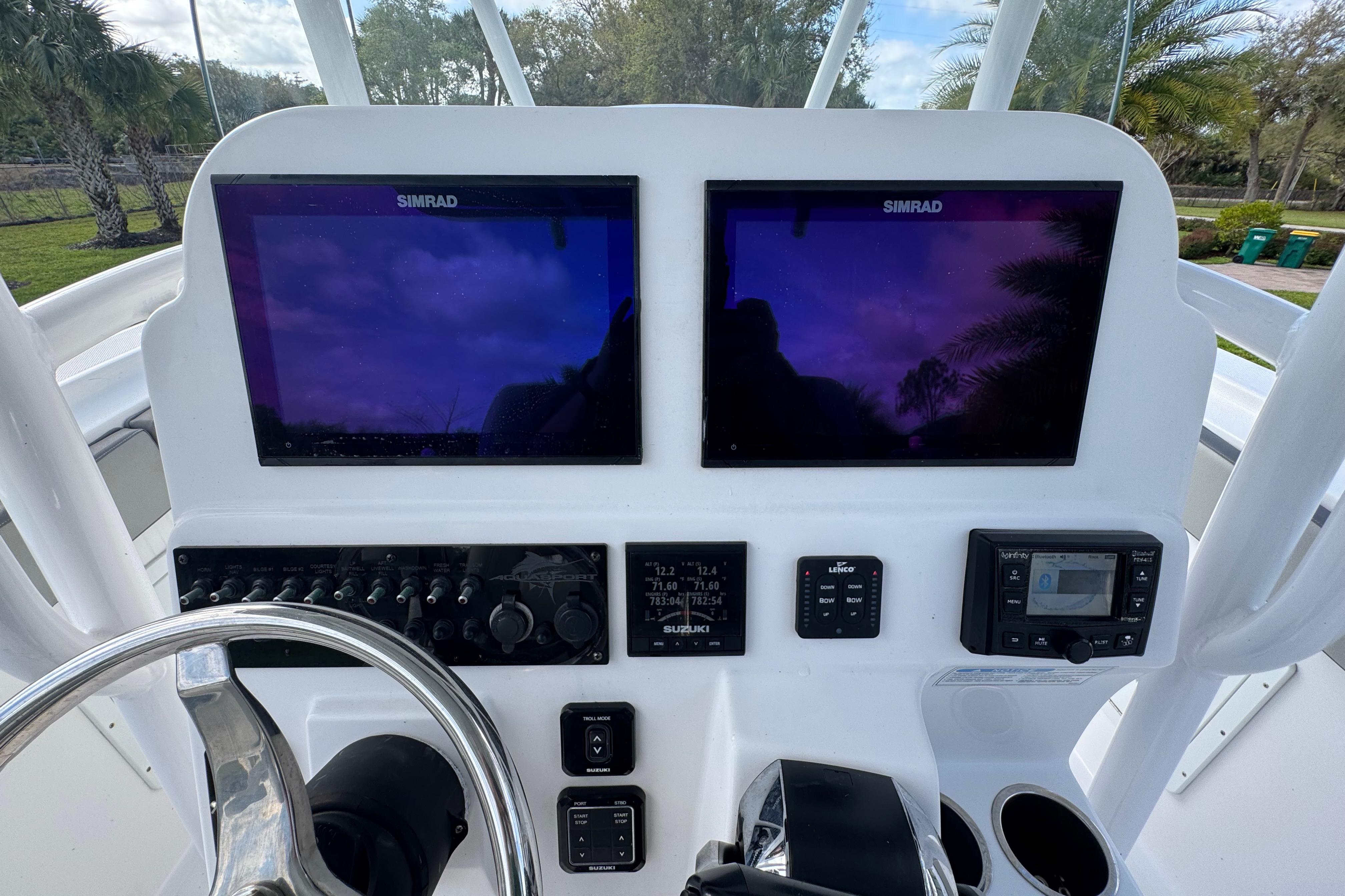 Control panel of 2022 Aquasport 2500 Center Console with dual Simrad displays.