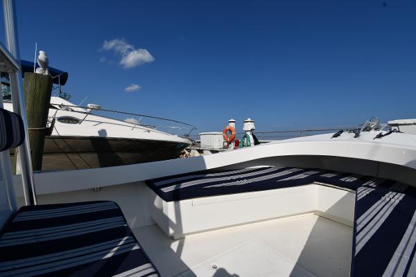 2021 Eastern 248 Center Console boat docked with striped seating and clear blue sky.