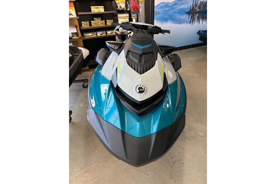 2025 Sea-Doo GTI SE 130 jet ski in showroom, featuring sleek design and vibrant colors.