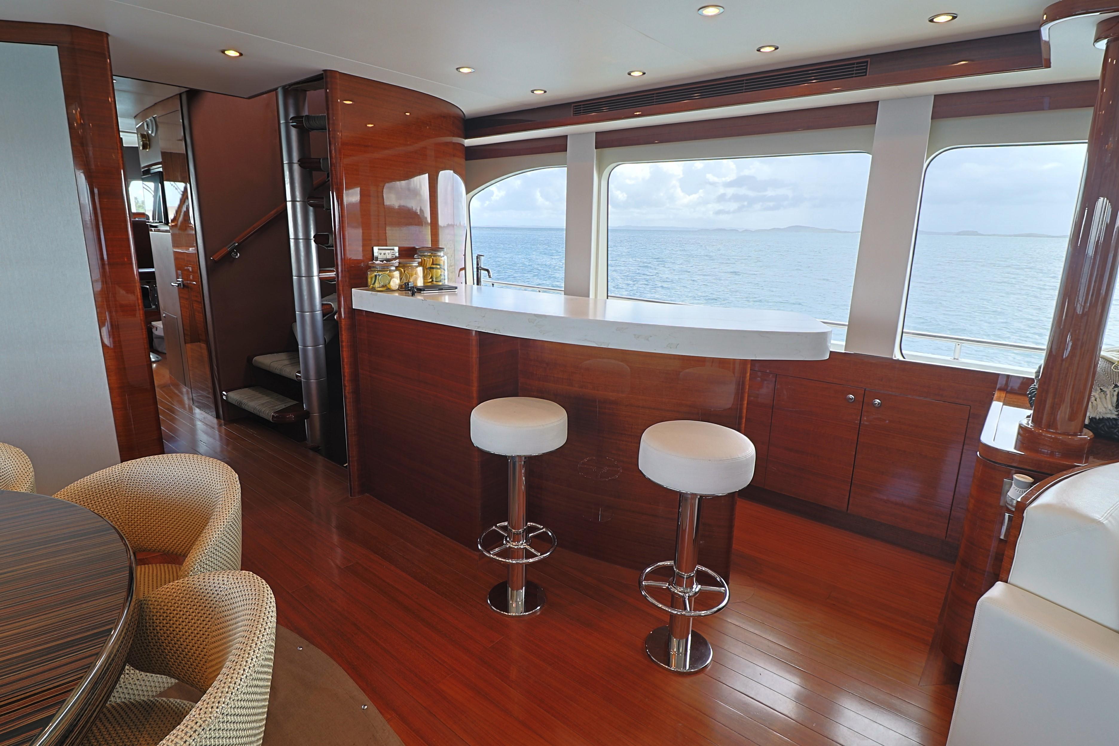 Luxurious interior of 2013 Cheoy Lee Bravo yacht with bar and ocean view.