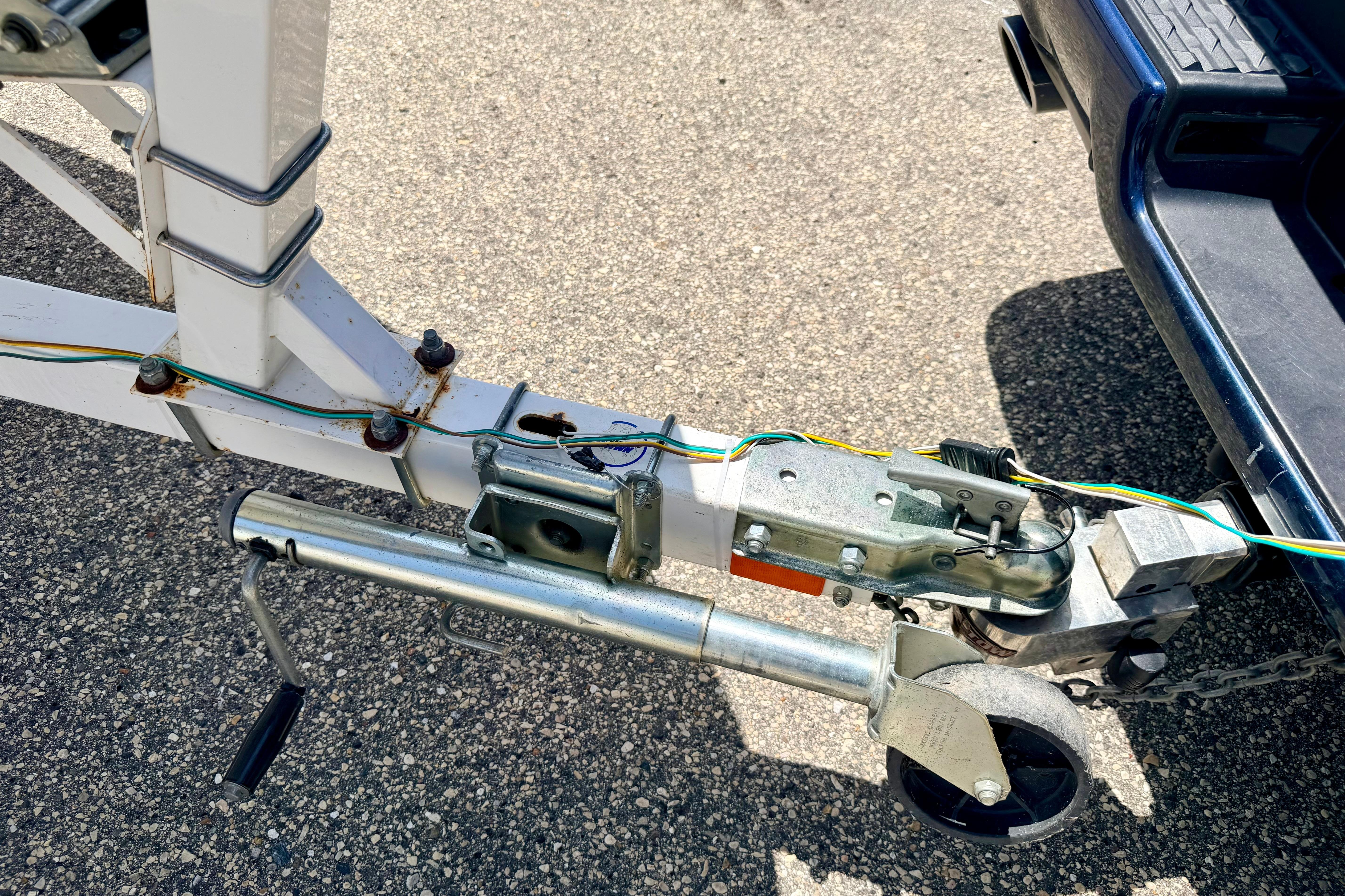 Trailer hitch and wiring for 2004 Bombardier SEADOO Utopia 185 on asphalt surface.