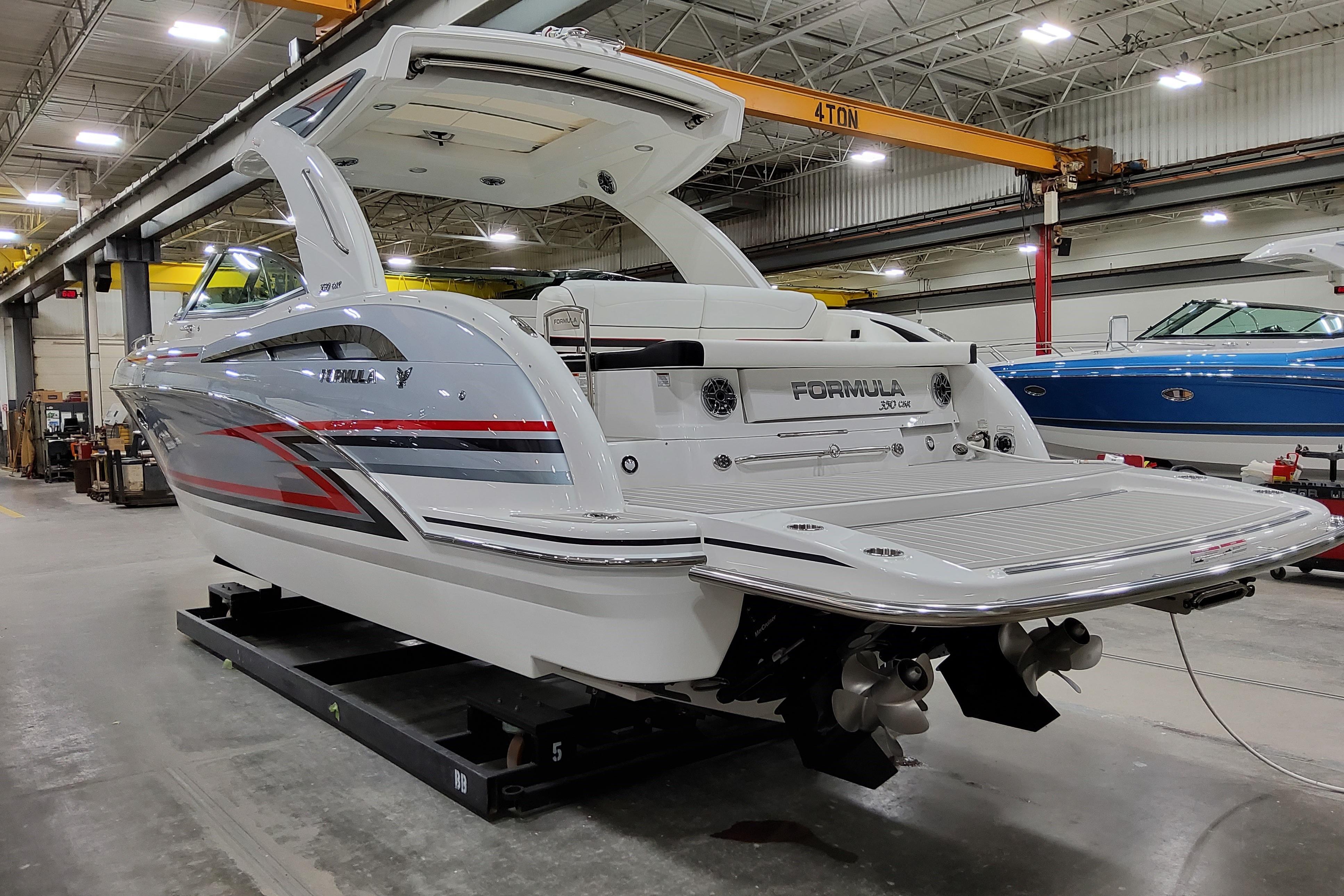 2027 Formula 350 Crossover Bowrider I/O in a showroom, showcasing sleek design and modern features.