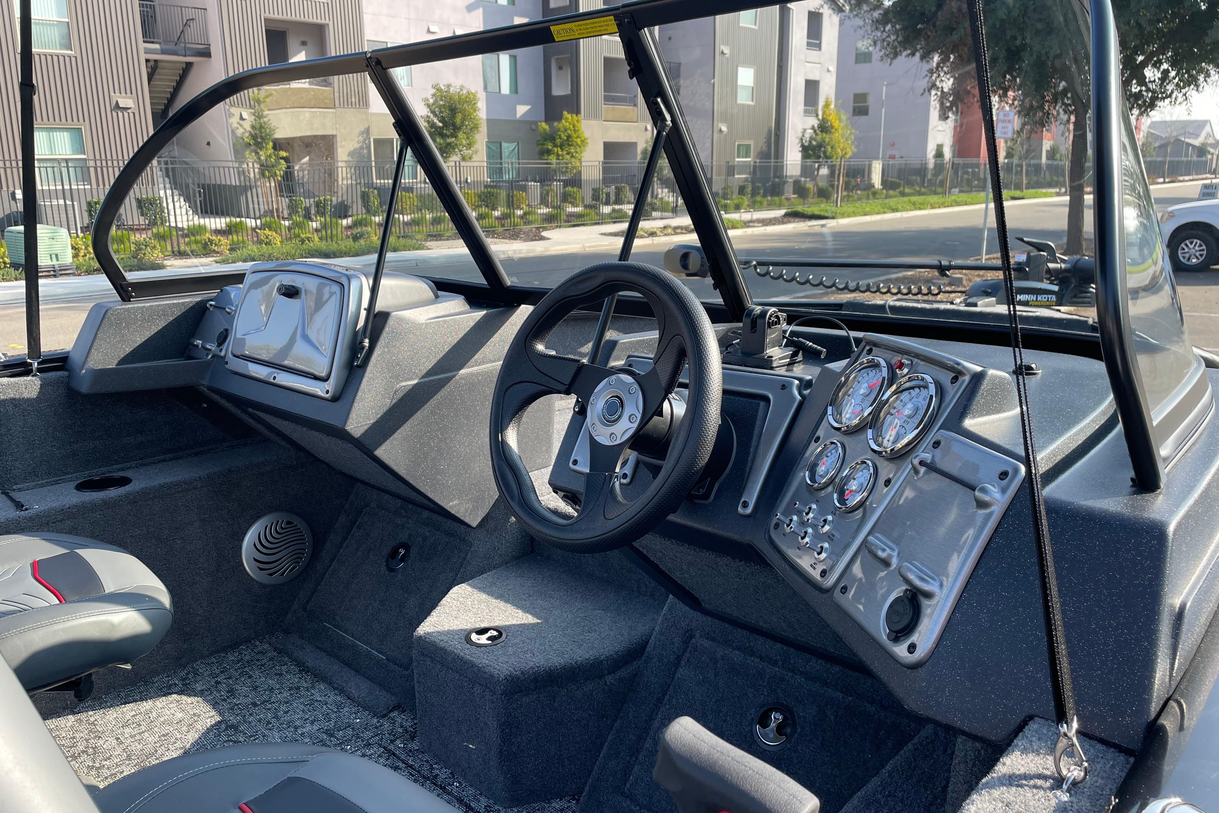 2026 Tracker Pro Guide V-175 WT boat interior with steering wheel and control panel.