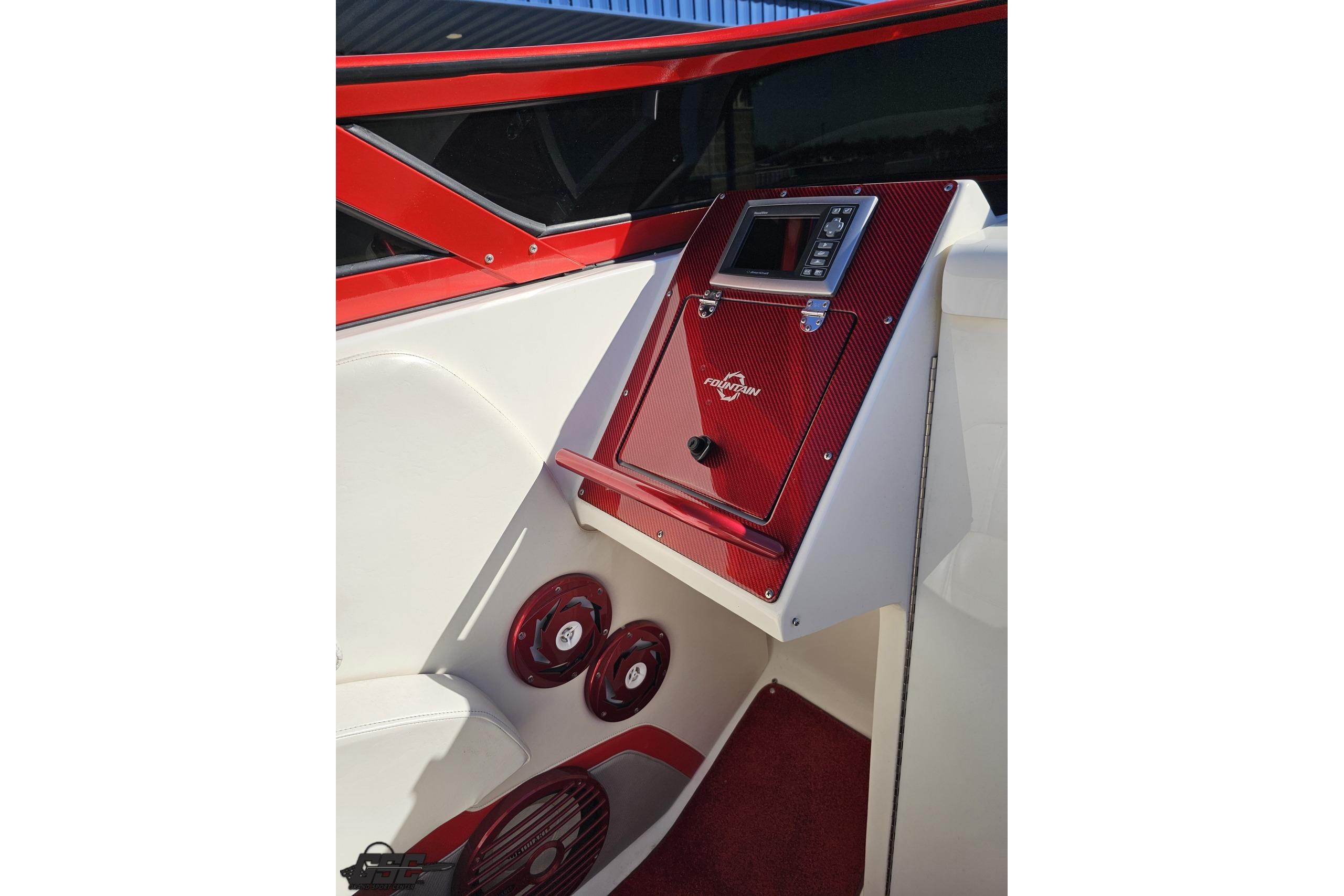 2009 Fountain 47 Lightning boat interior with red accents and control panel.