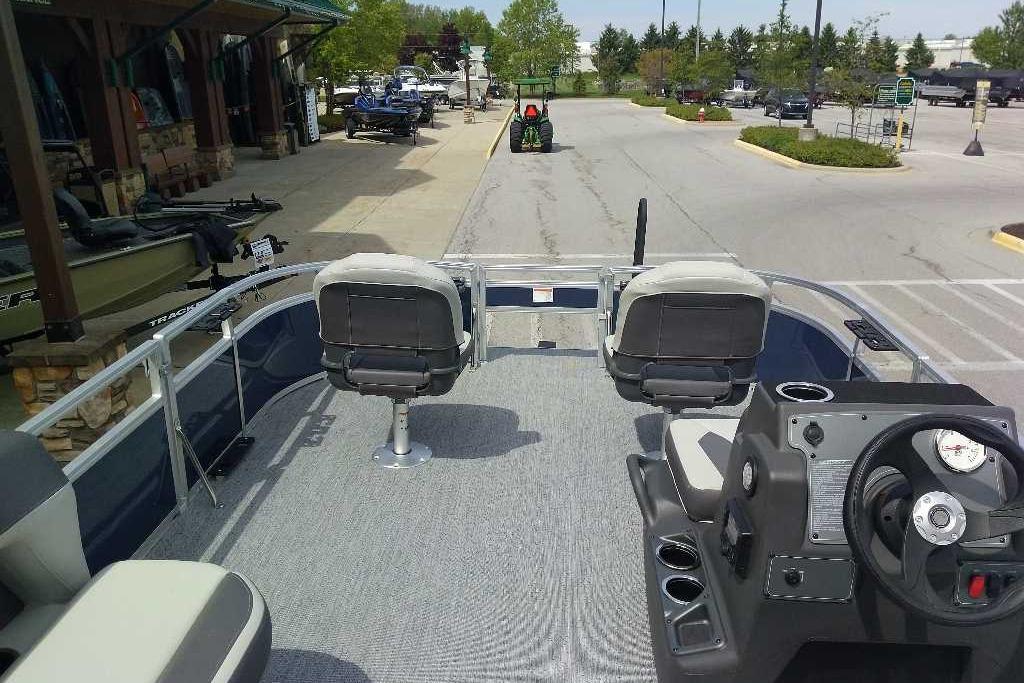 2026 Sun Tracker Bass Buggy 16 XL Select pontoon boat at a dealership.