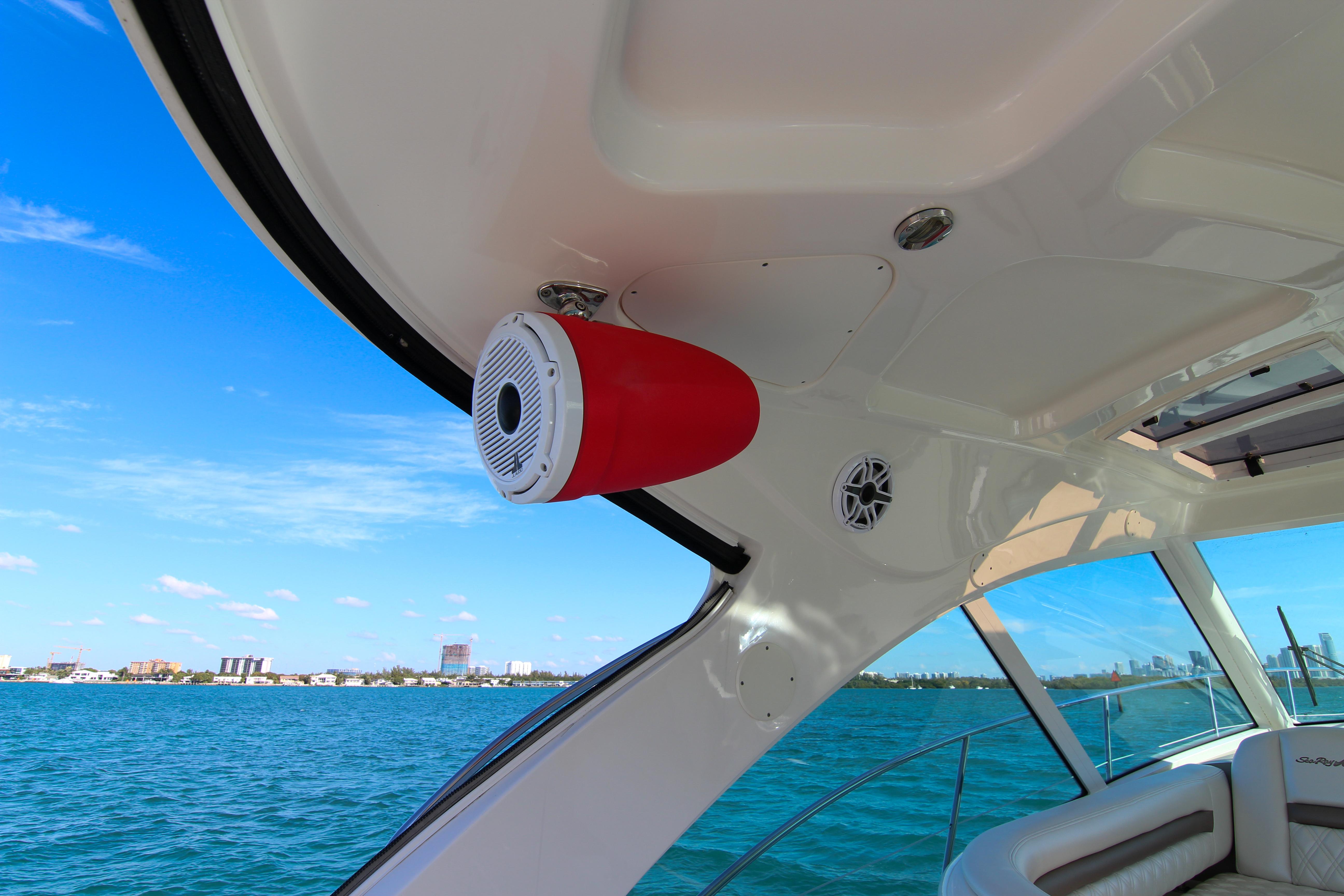 2008 Sea Ray 48 Sundancer yacht interior with speaker, overlooking blue ocean and city skyline.