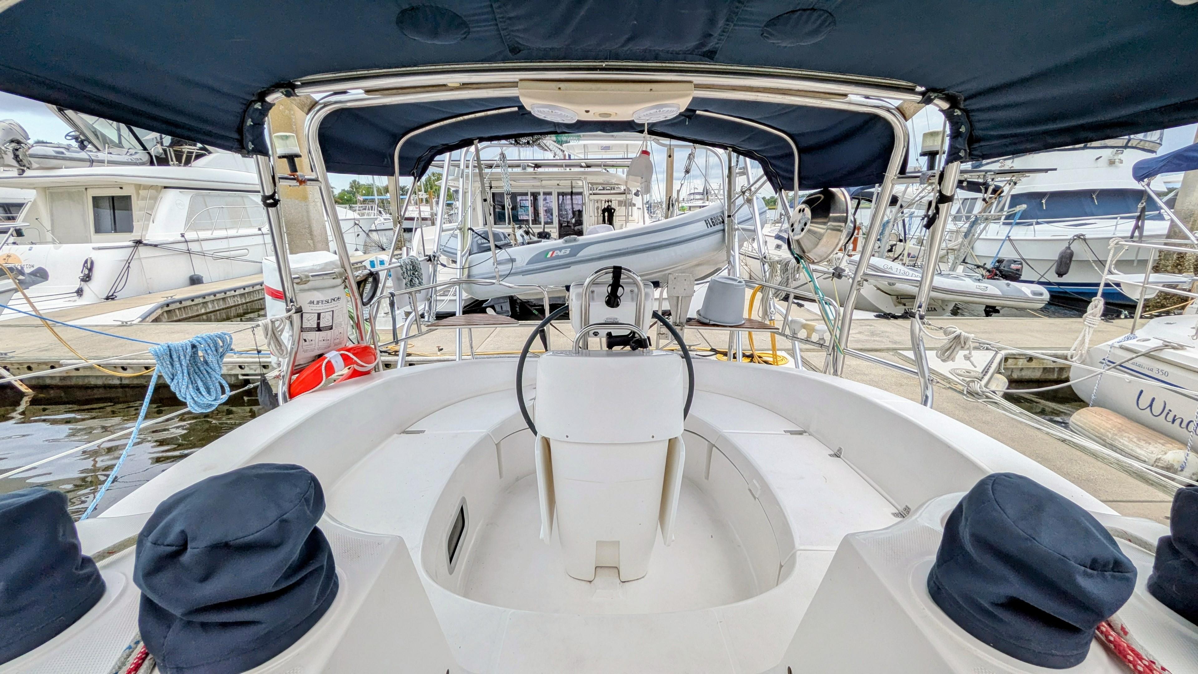 Cockpit view of a 2001 Hunter 380 sailboat docked at a marina.