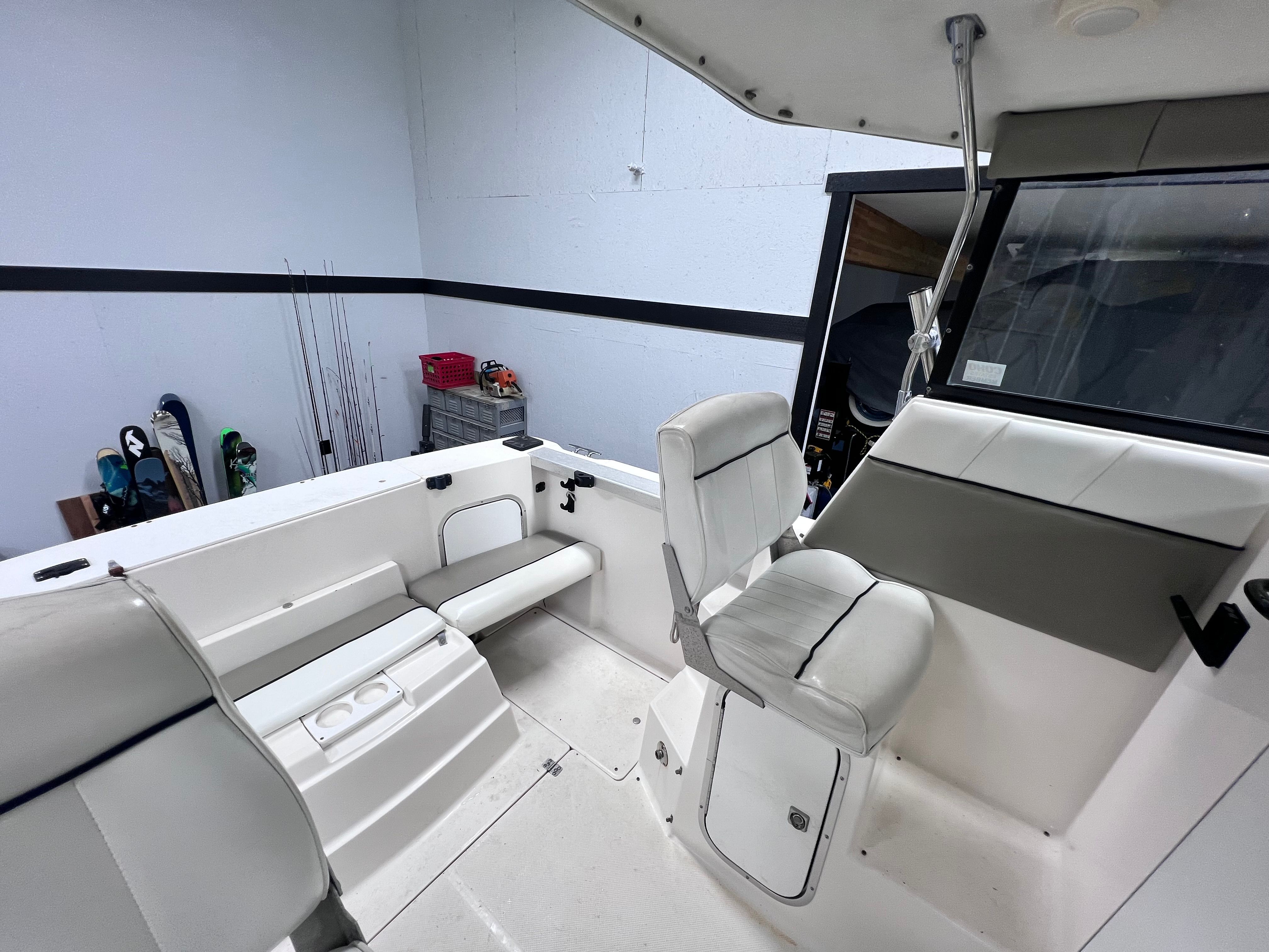 Interior of a 1997 Bayliner 2452 boat with white seating.