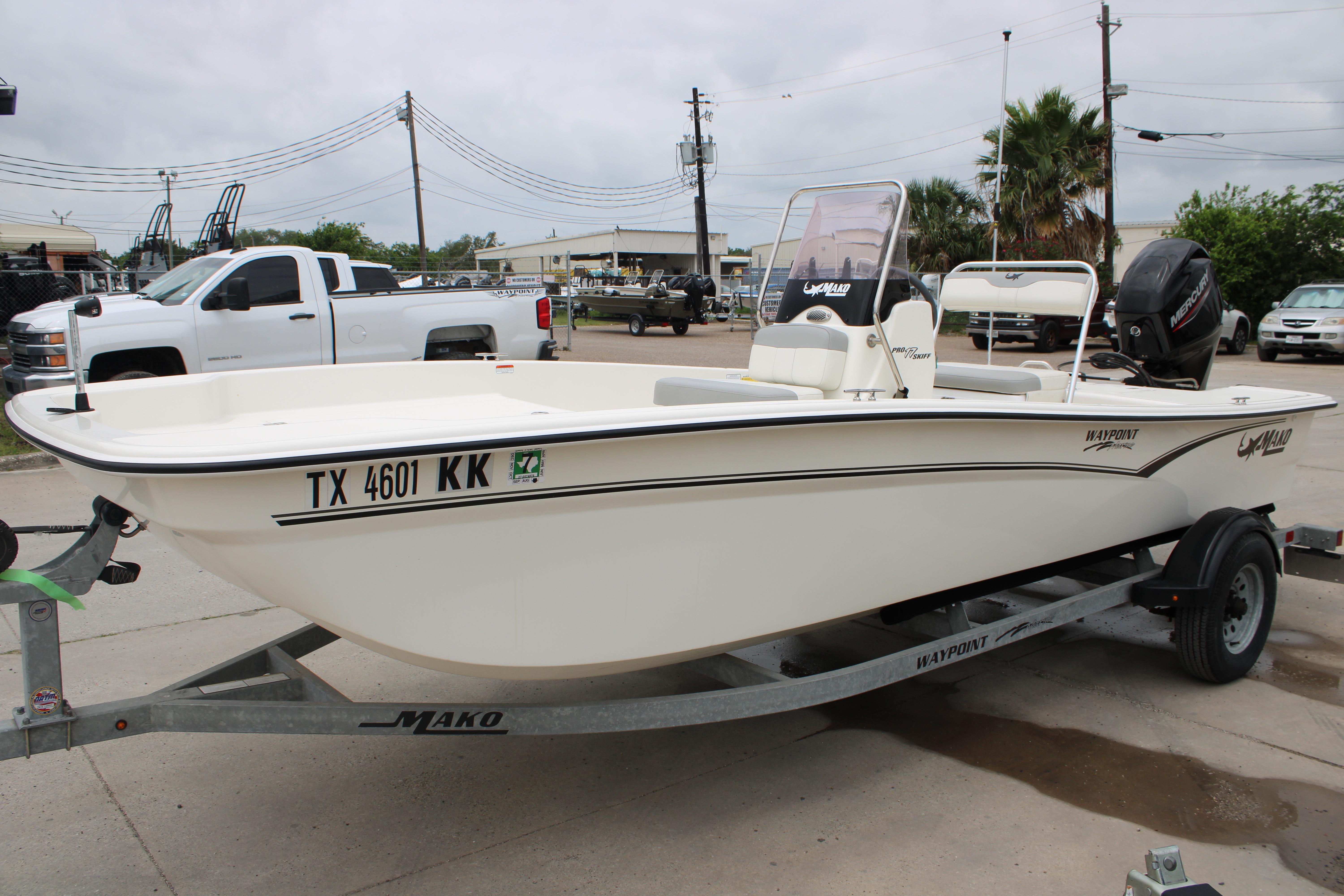 2021 Mako Pro Skiff 17 CC boat on trailer, parked outdoors.